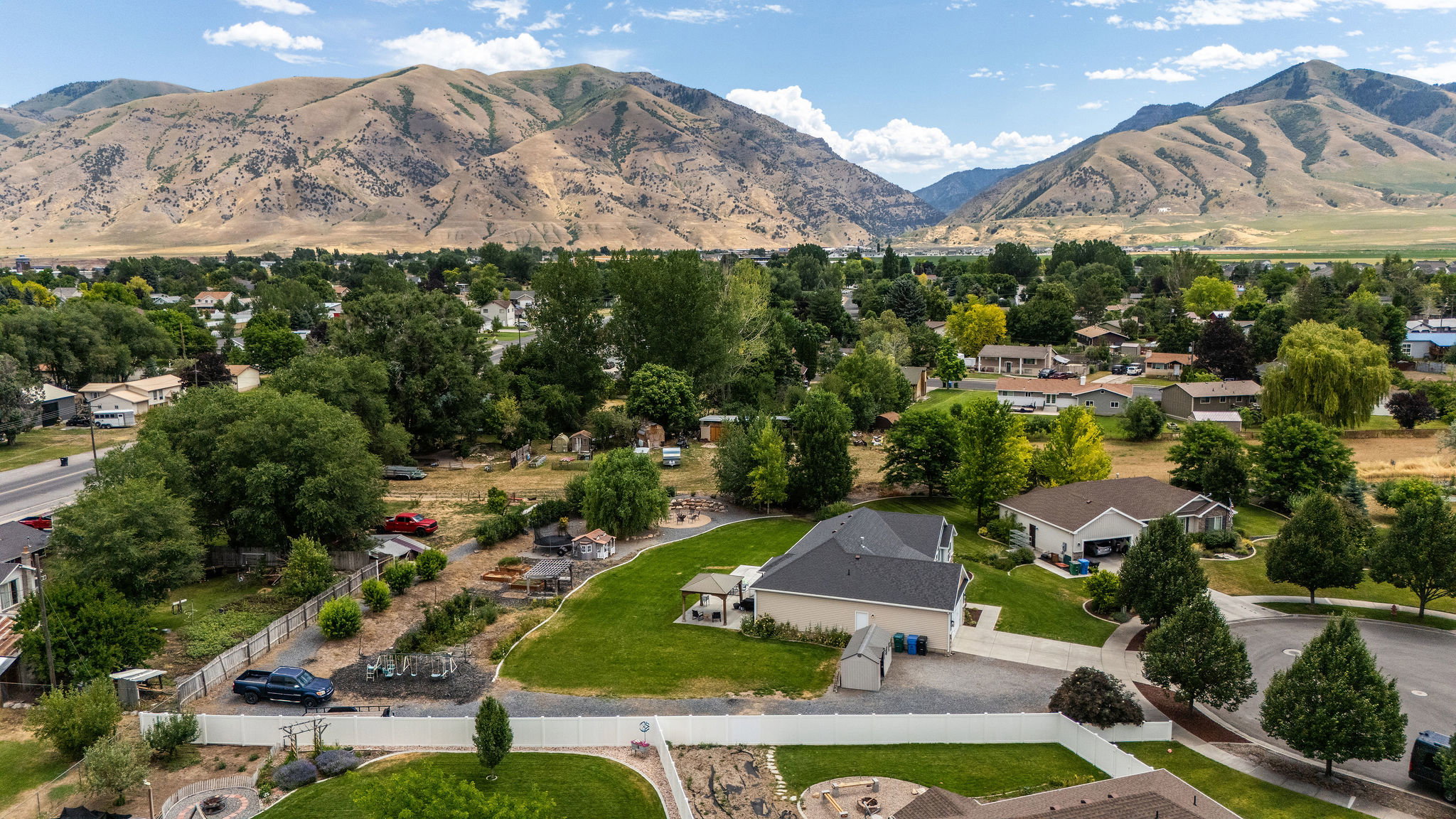 Aerial perspective showcasing a residential neighborhood with mountain backdrop