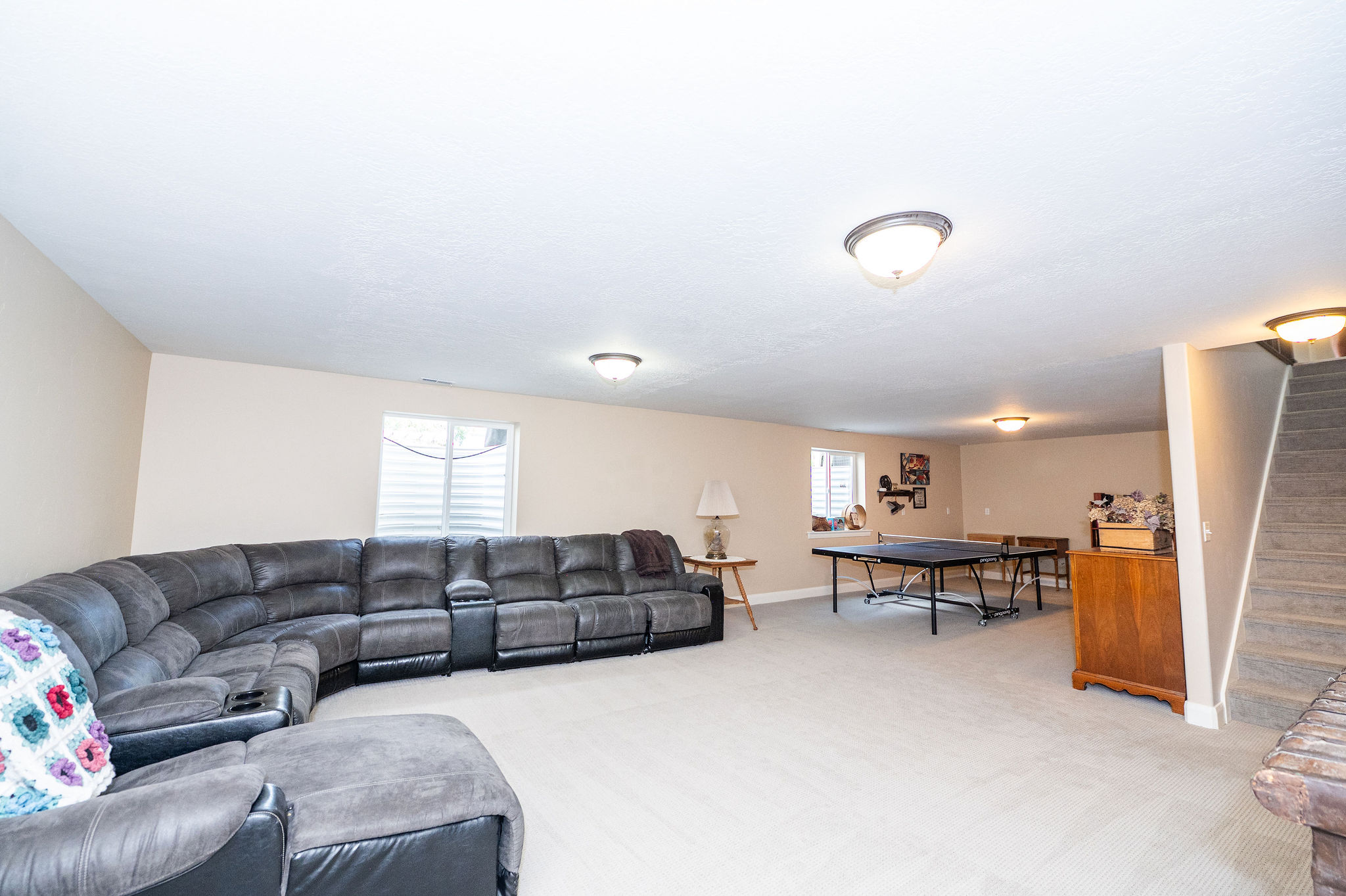 Spacious room with light-toned carpeting and neutral wall paint