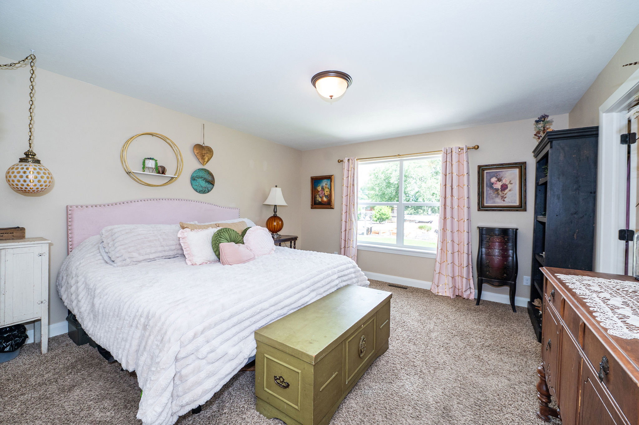 Carpeted room featuring a single window, a flush-mount ceiling light, and neutral wall tones