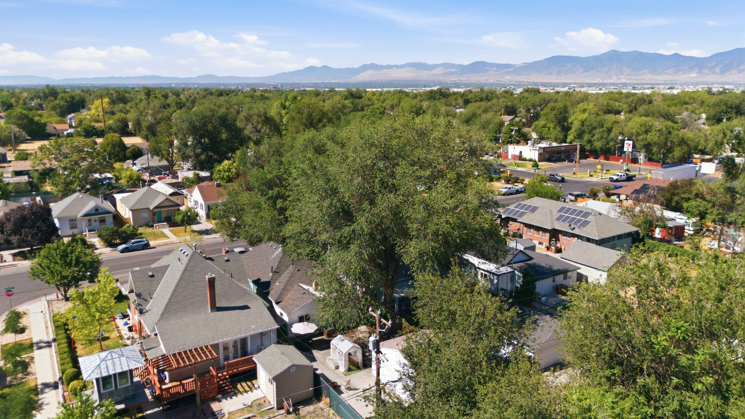 Aerial perspective showcasing a residential neighborhood with a distant mountain range backdrop