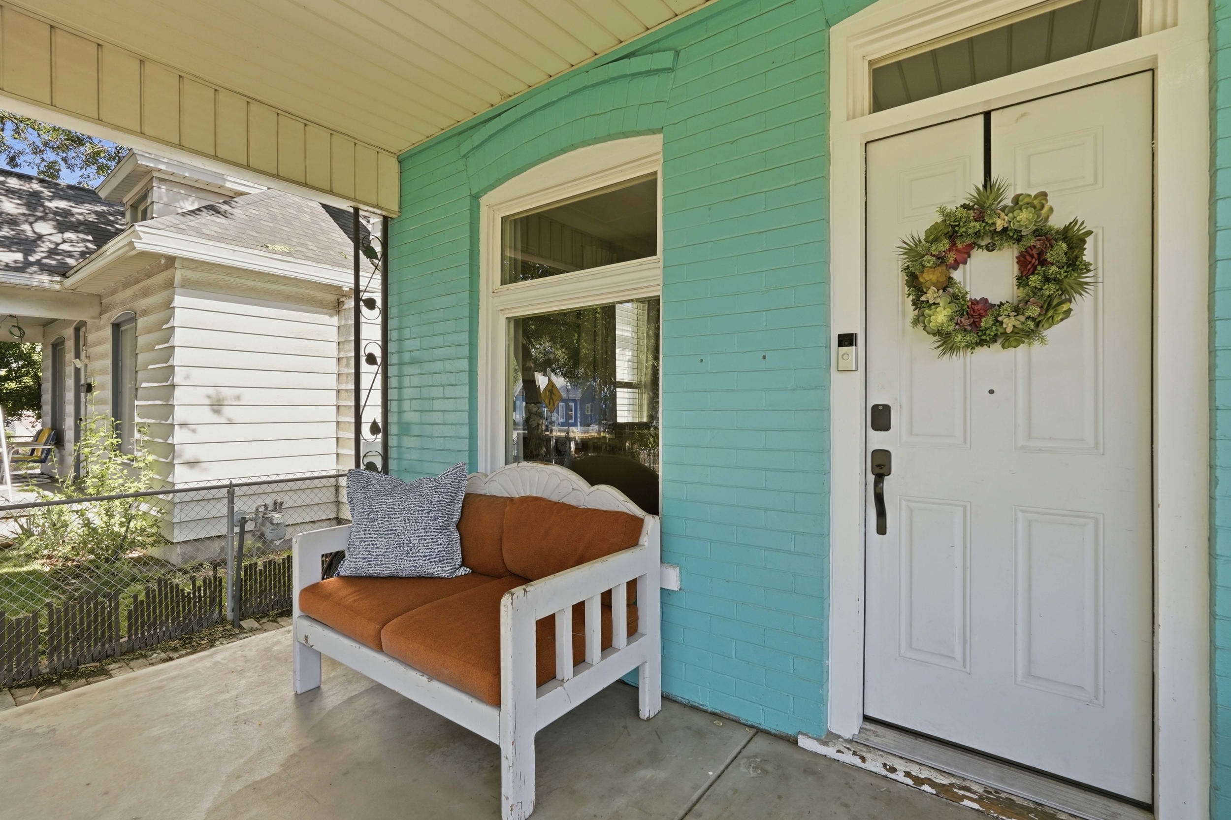 Front entry featuring a white paneled door with a transom window above