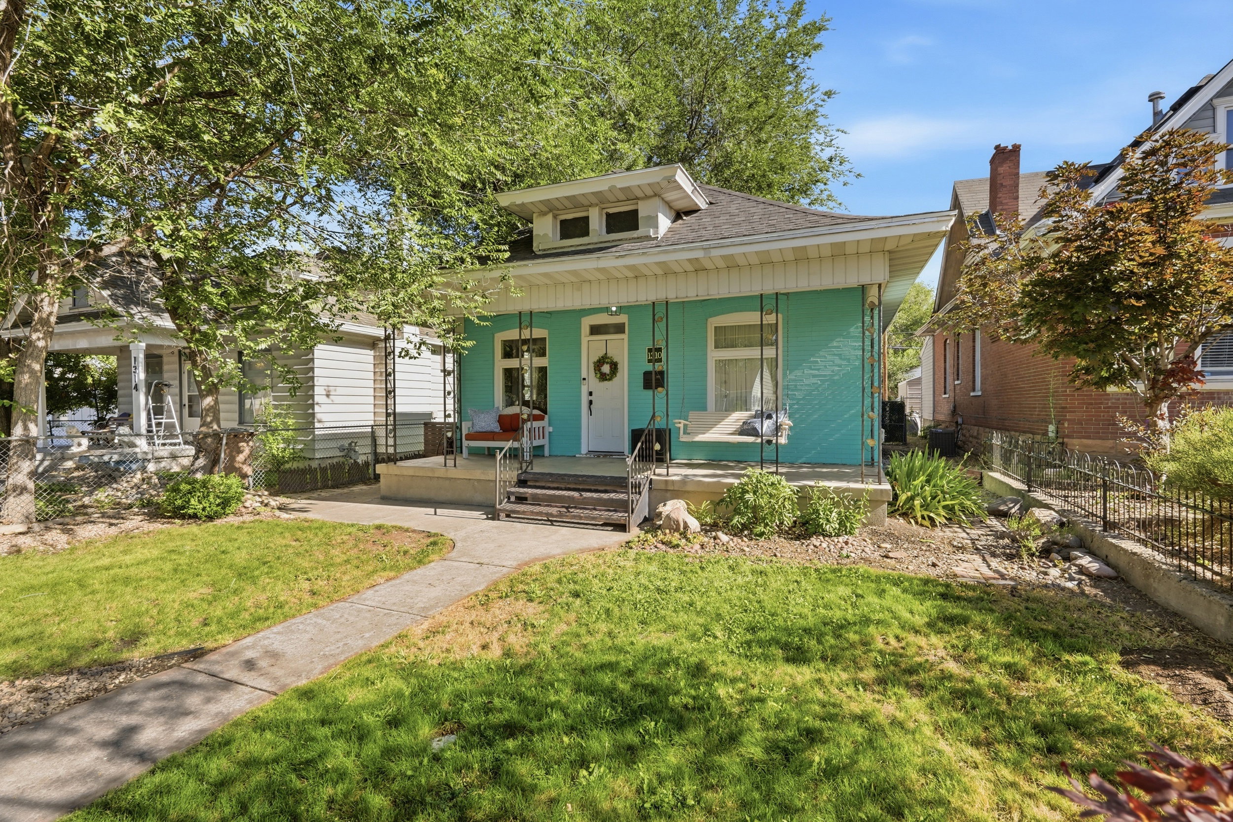 Single-story residence featuring a covered front porch and a light blue exterior