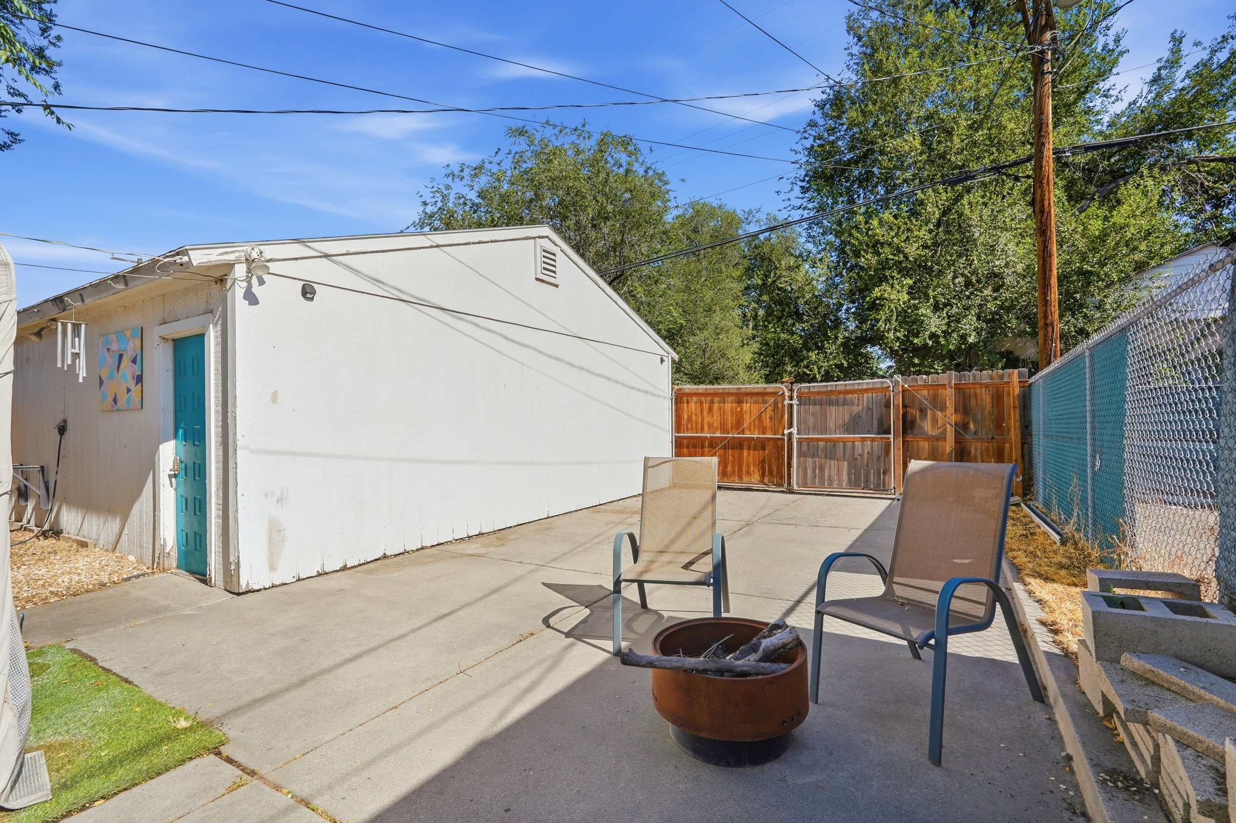 Concrete patio space, secure RV Parking available.  Solid privacy fence and chain link fencing. Door entrance to large 2 car garage.
