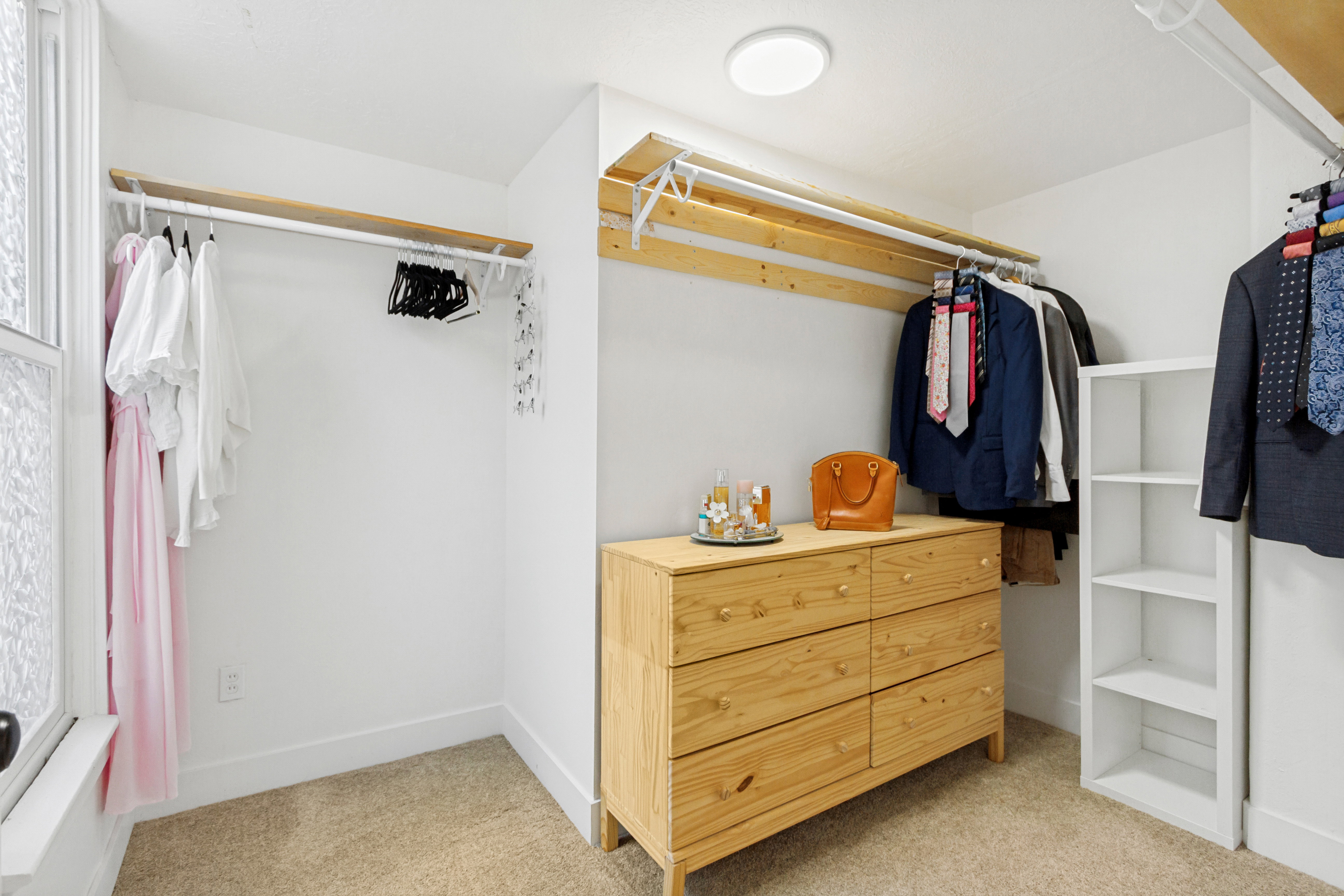 Well-organized closet with carpet flooring