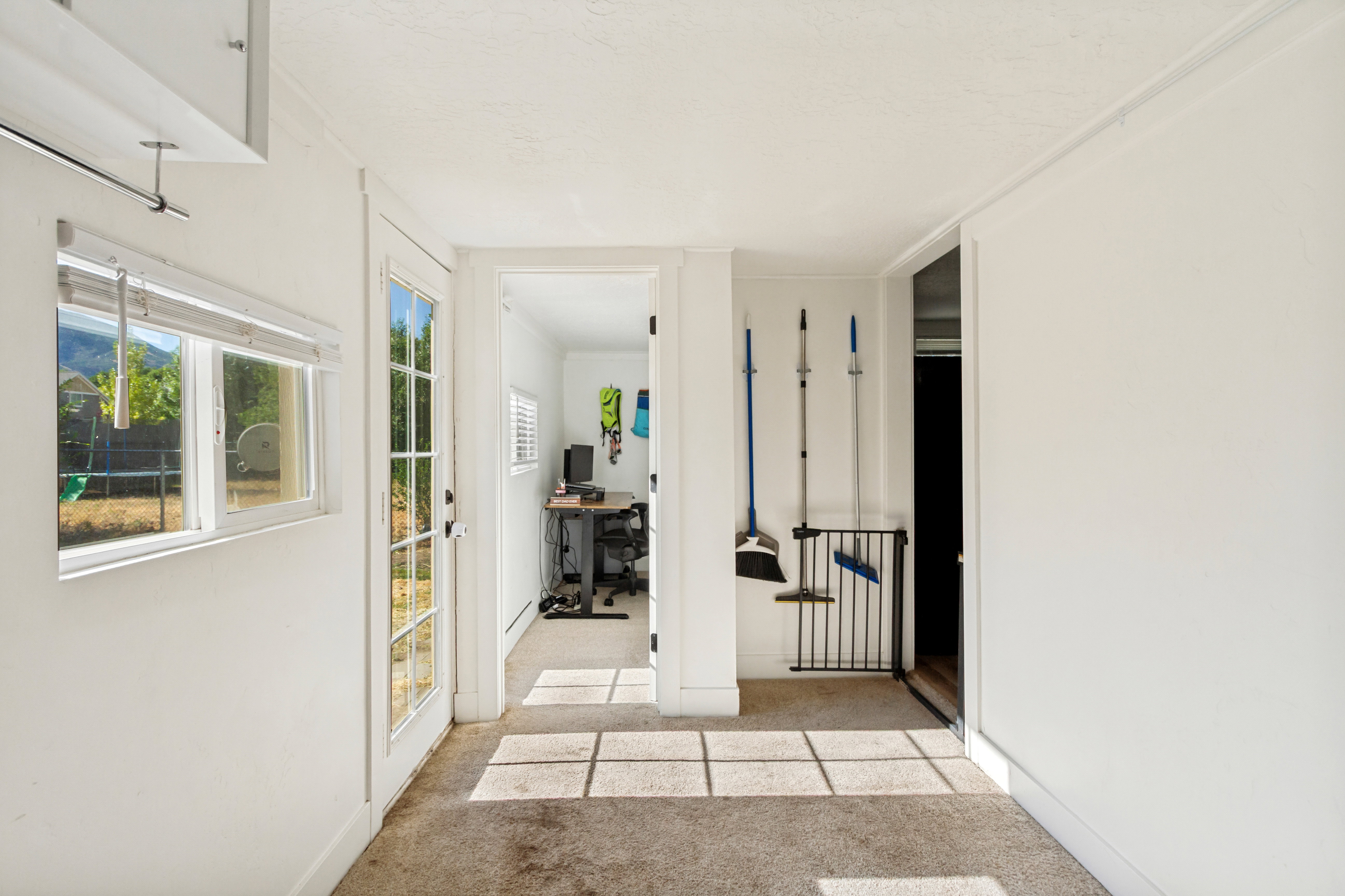 Interior space with light-colored walls and carpeted flooring