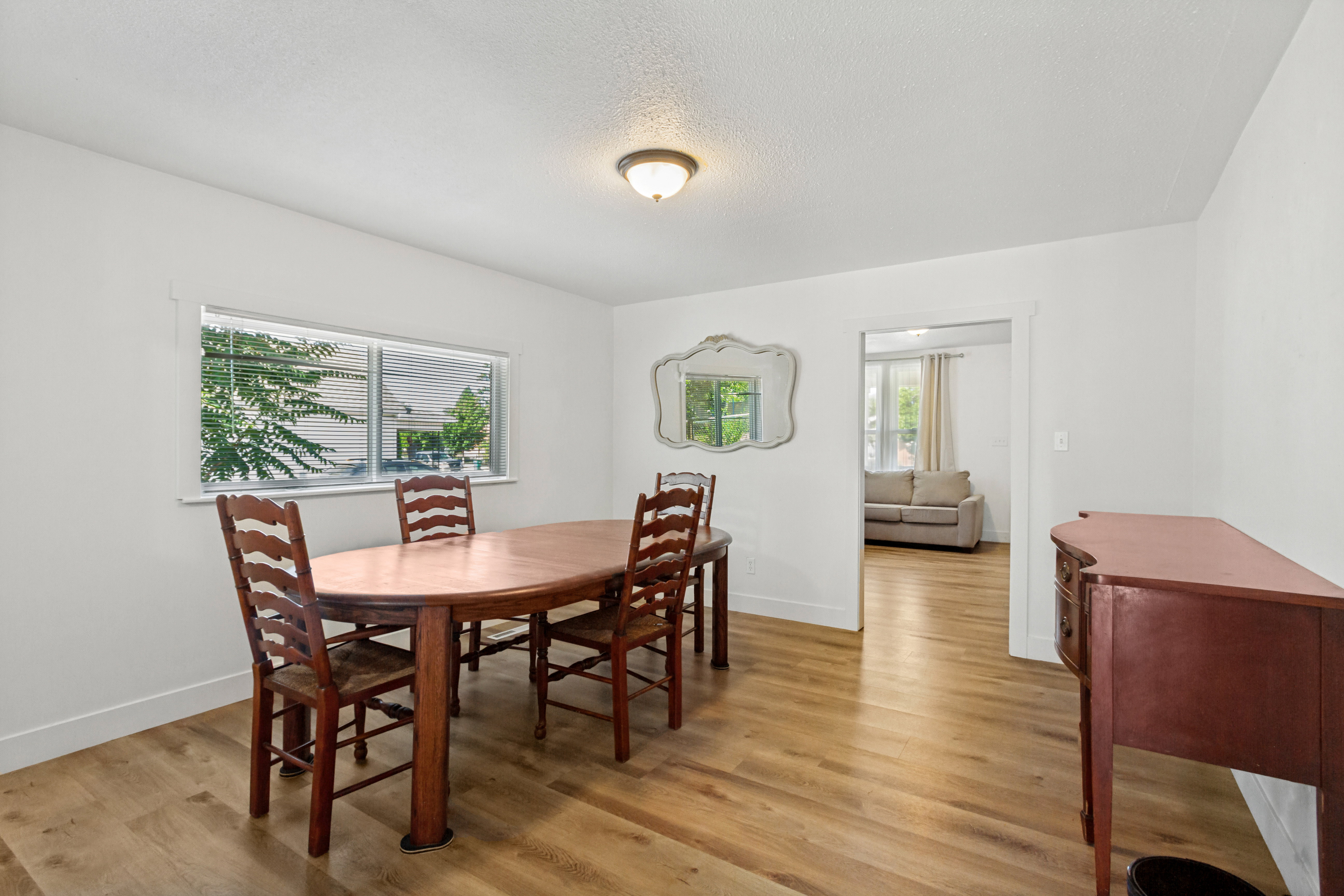 Dining area featuring laminate, white walls, and a ceiling-mounted light fixture