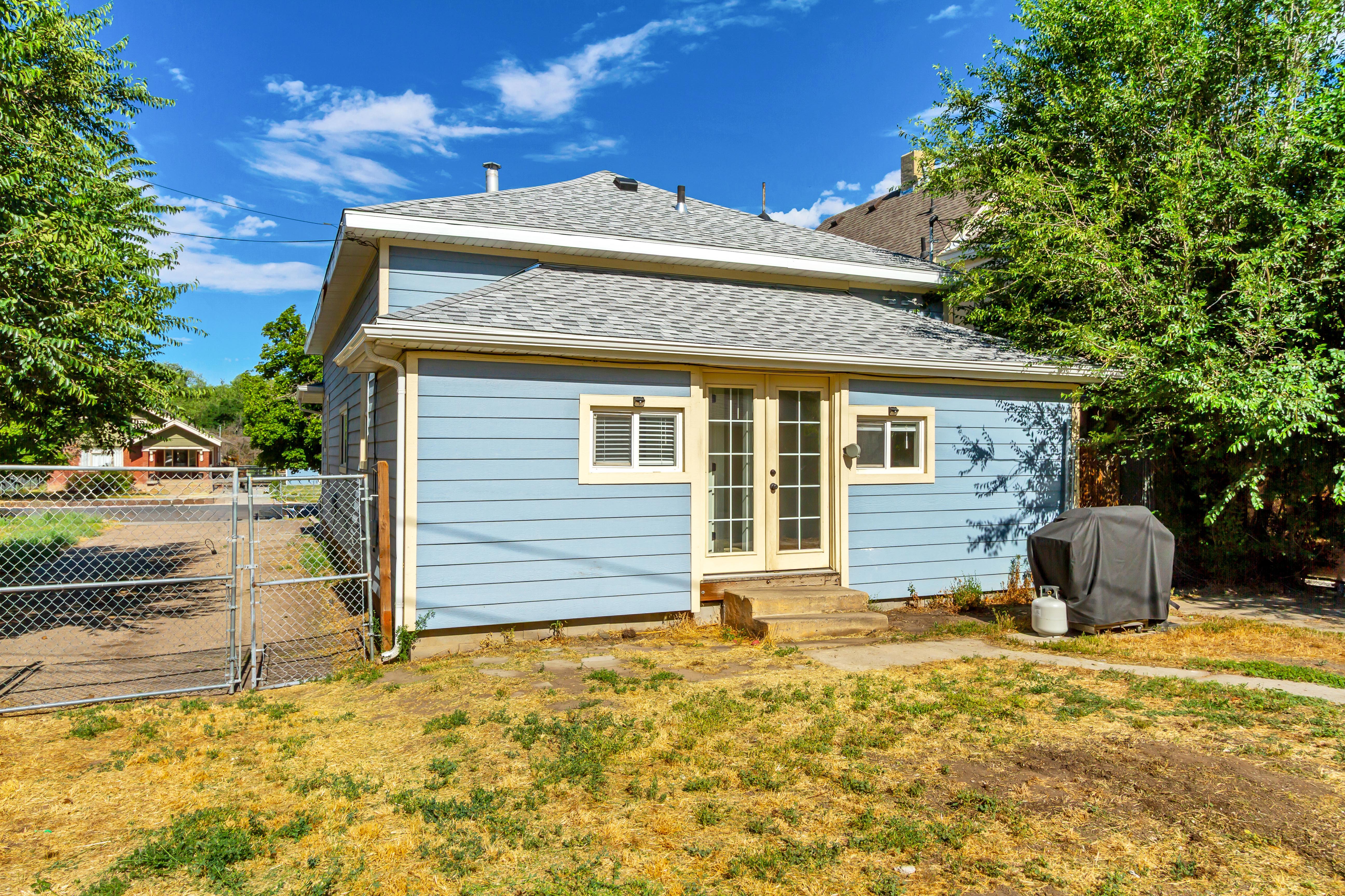 Light blue siding exterior featuring a gray shingle roof and white trim