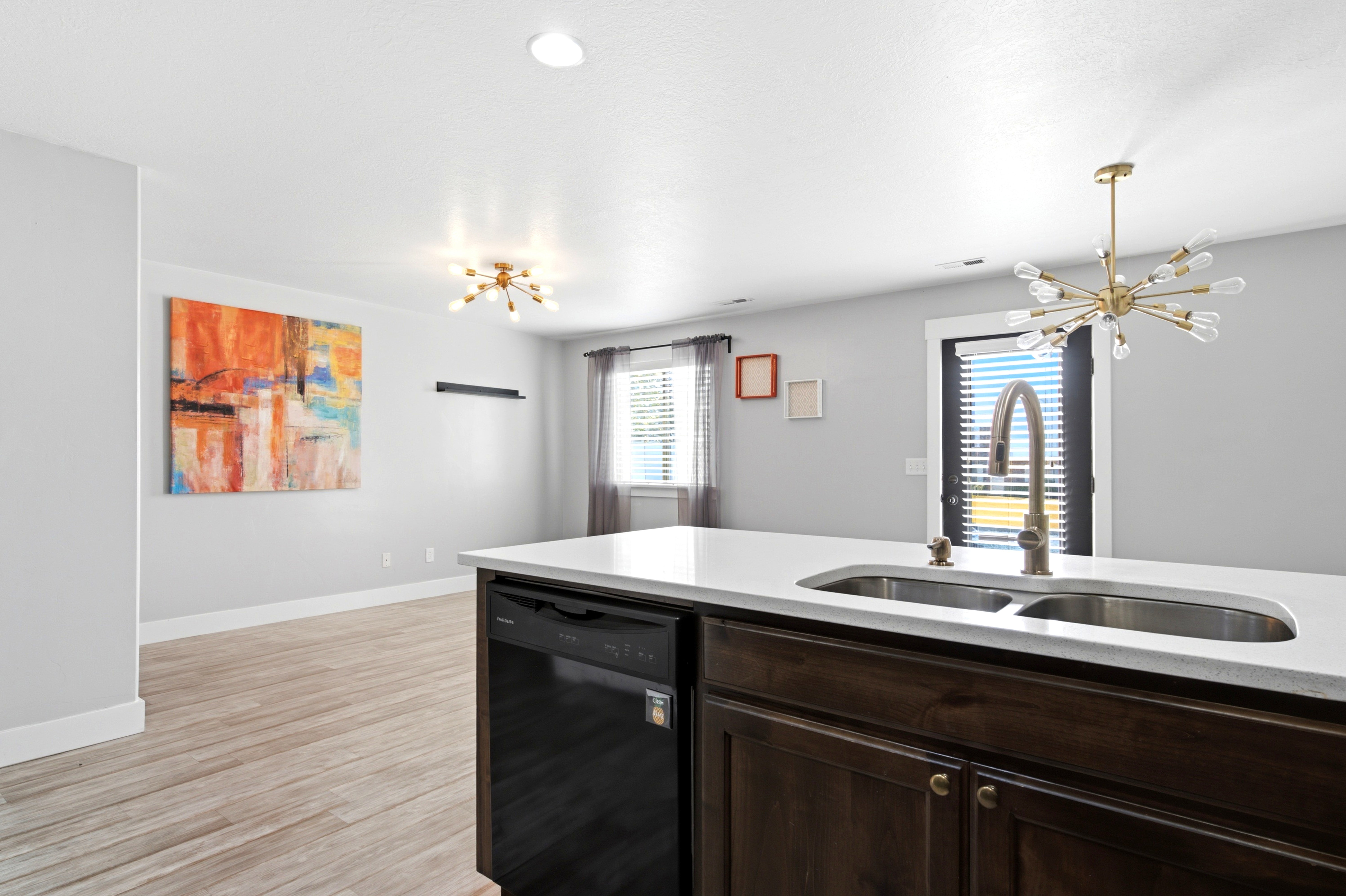 Kitchen island featuring a double basin stainless steel sink with a gooseneck faucet