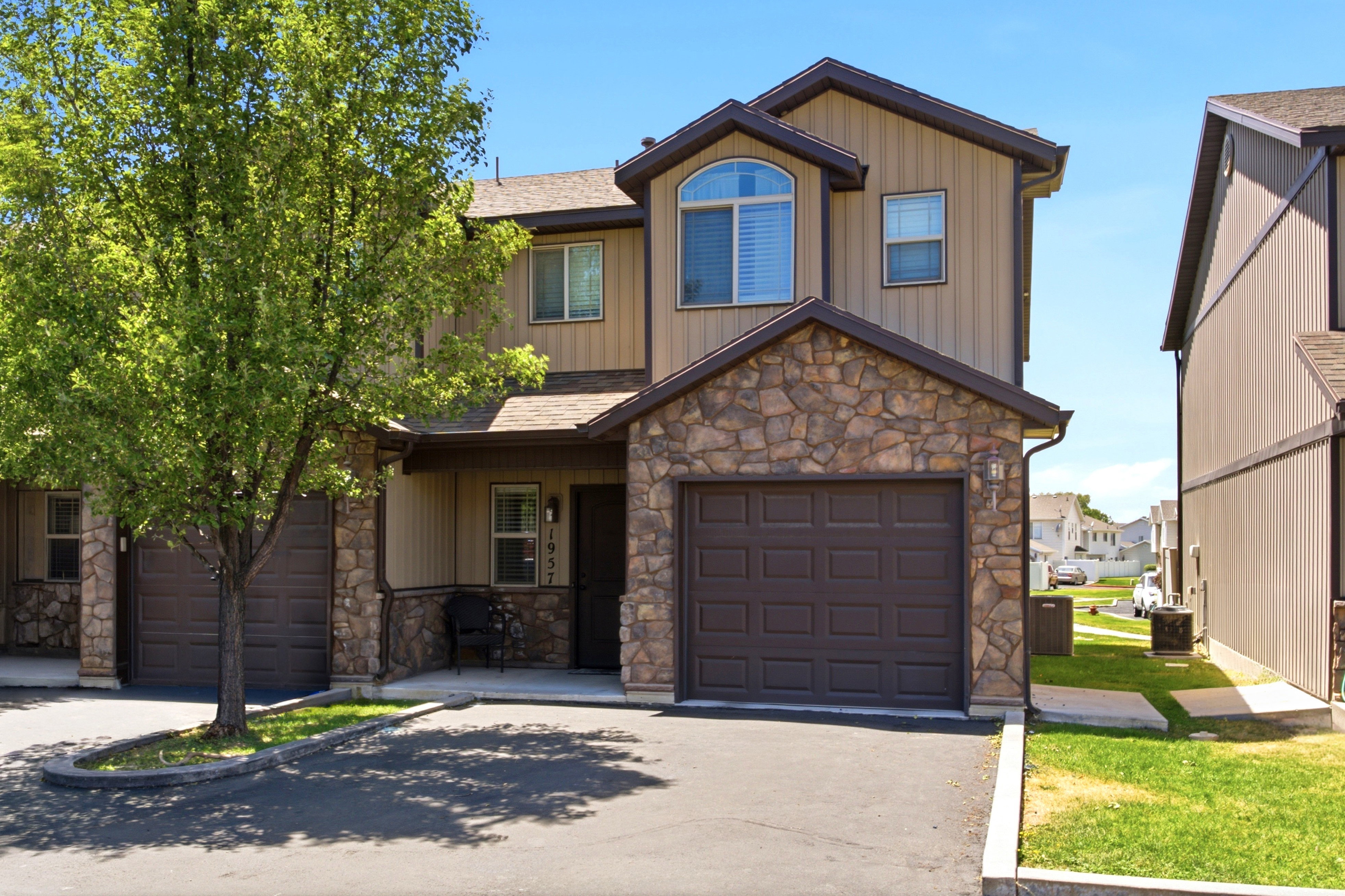 Two-story property featuring a stone and siding facade