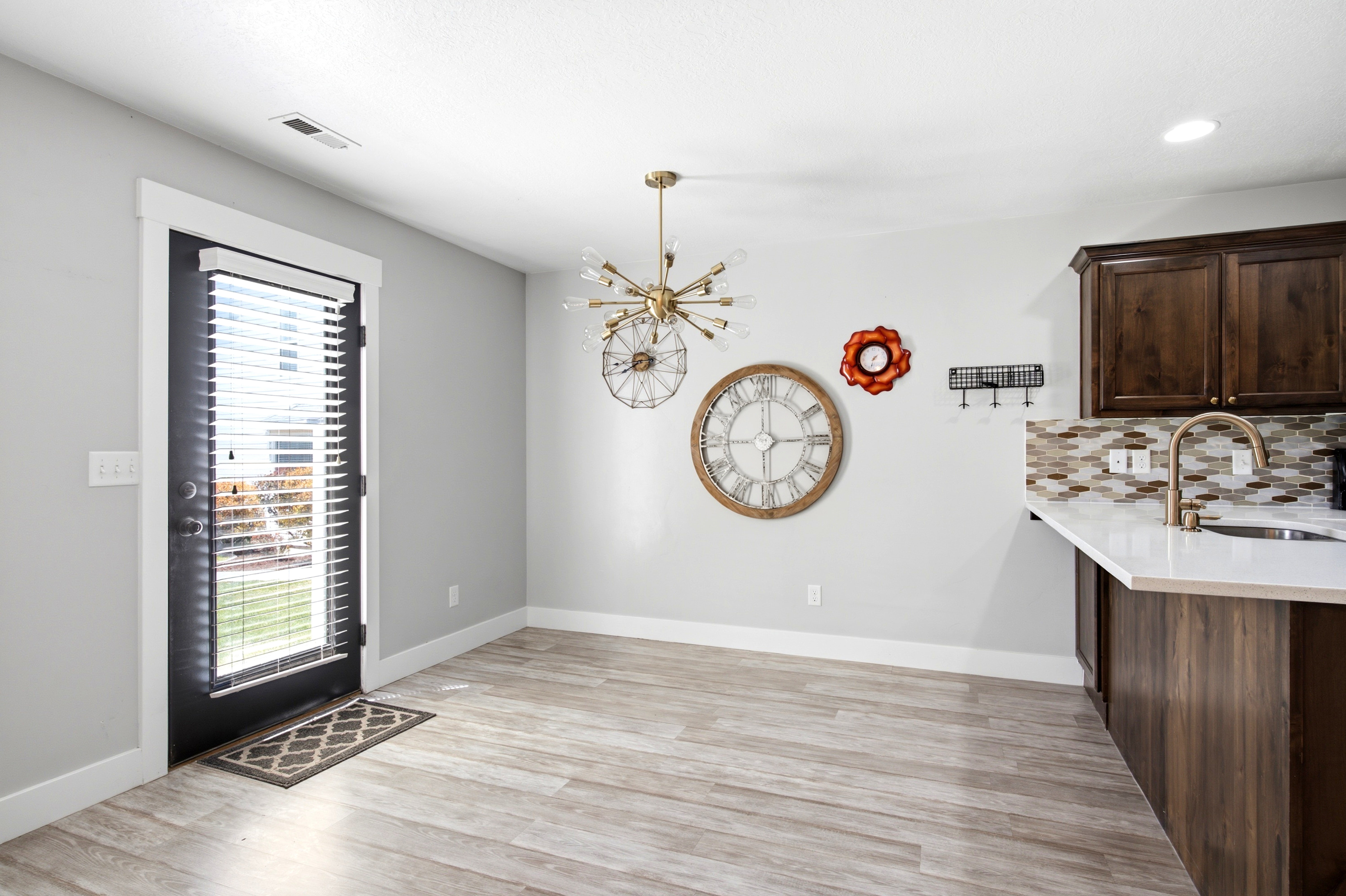 Light wood-finish flooring complements the neutral wall tones