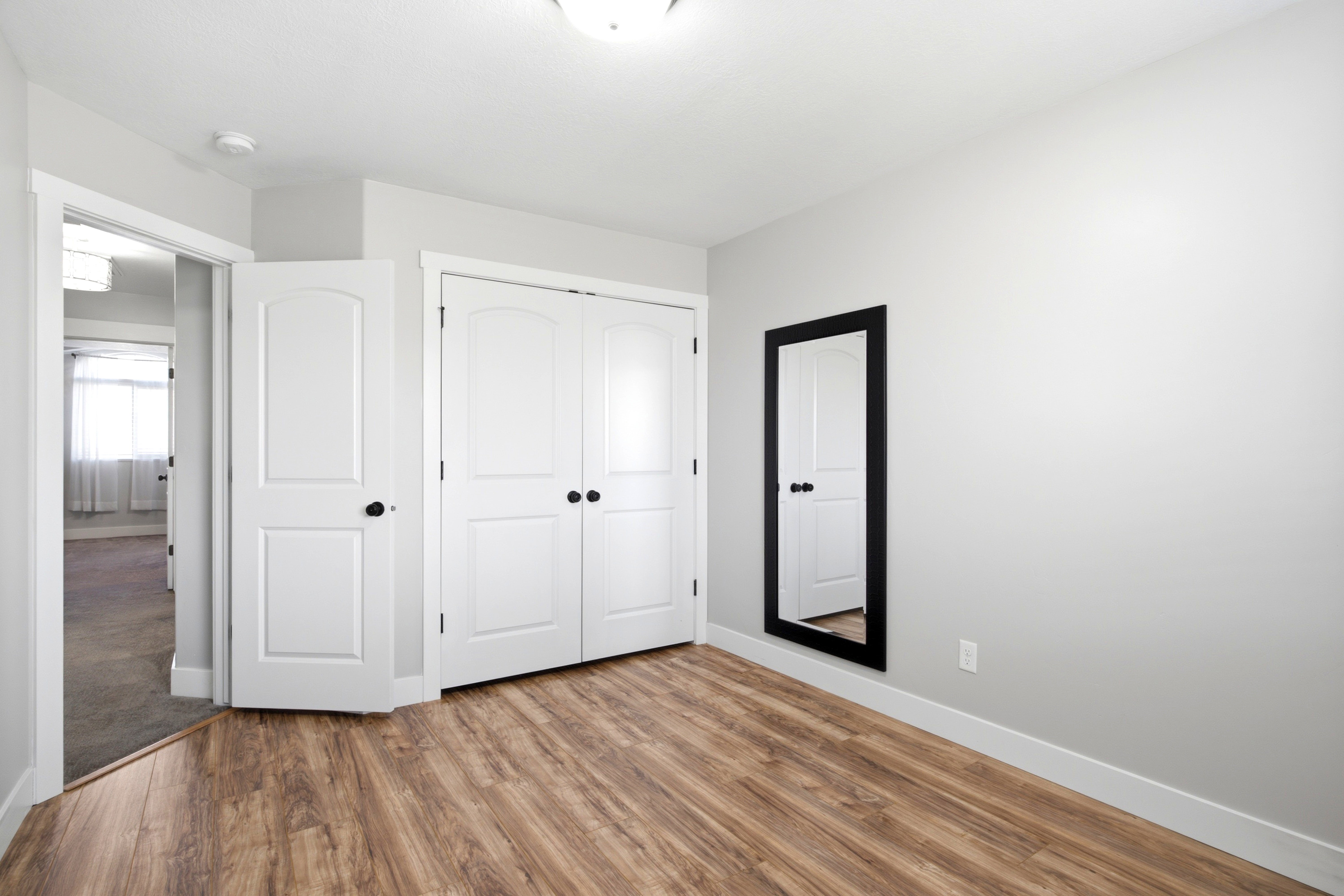 Wood-finish flooring complemented by light gray walls