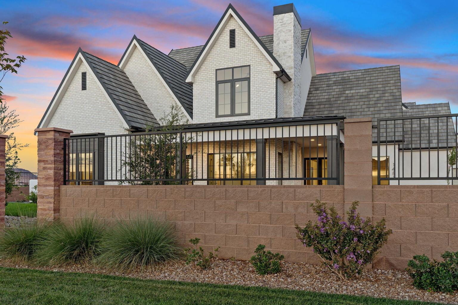 White brick exterior with prominent gables and dark gray roofing