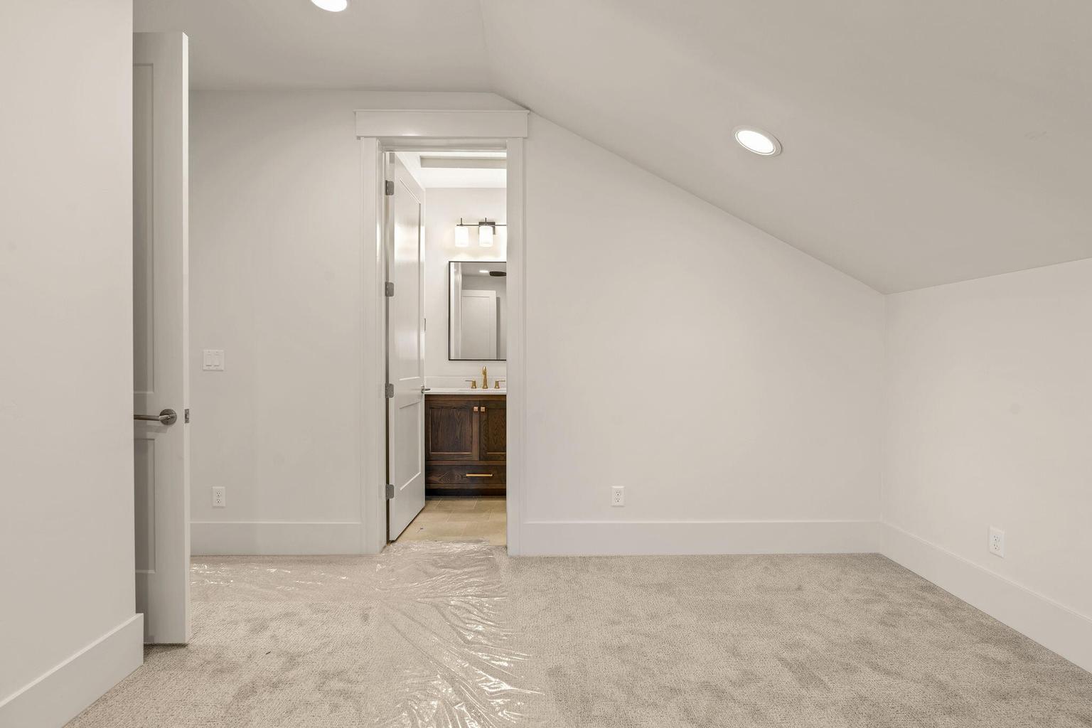 Carpeted room with recessed lighting and a neutral wall palette