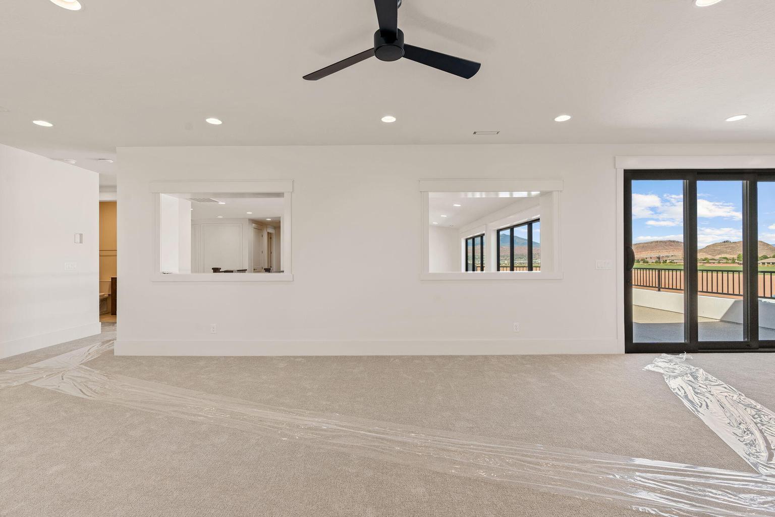 Spacious interior featuring neutral carpeting and recessed lighting