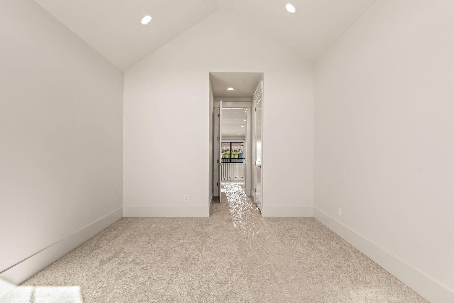 Neutral-toned carpeting paired with crisp white walls and white trim