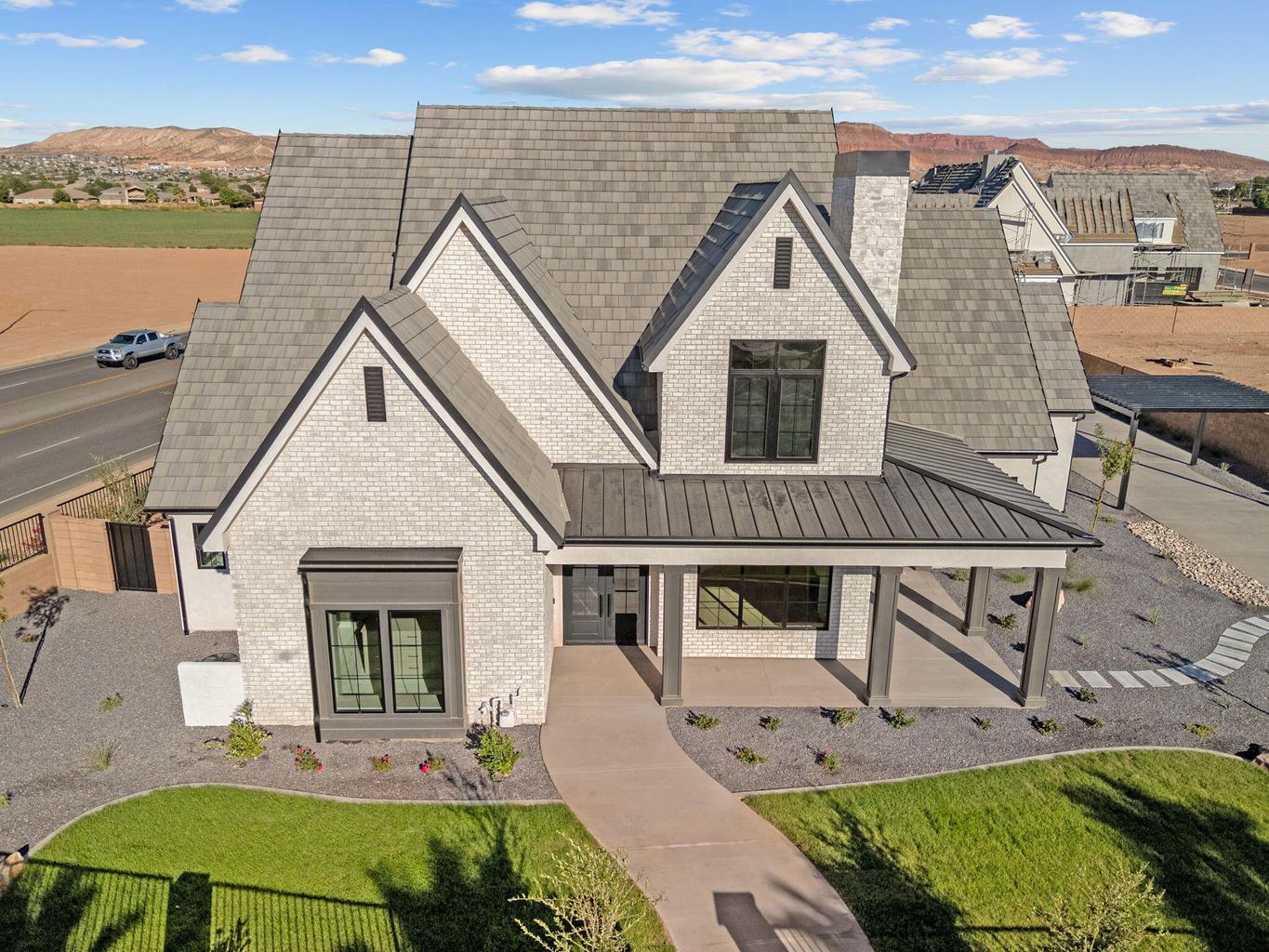 Modern farmhouse exterior with light brick and dark trim accents