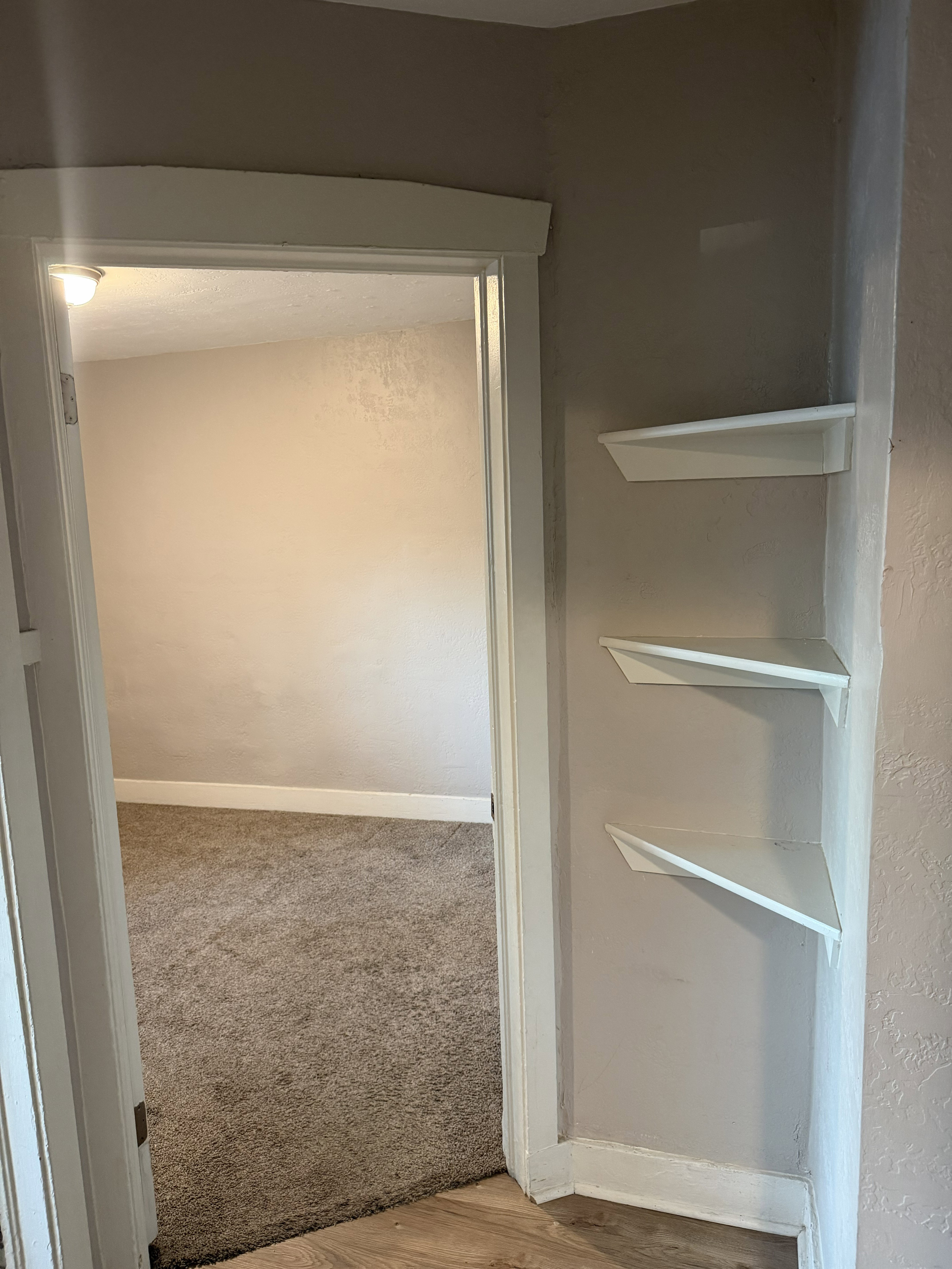 Three white corner floating shelves