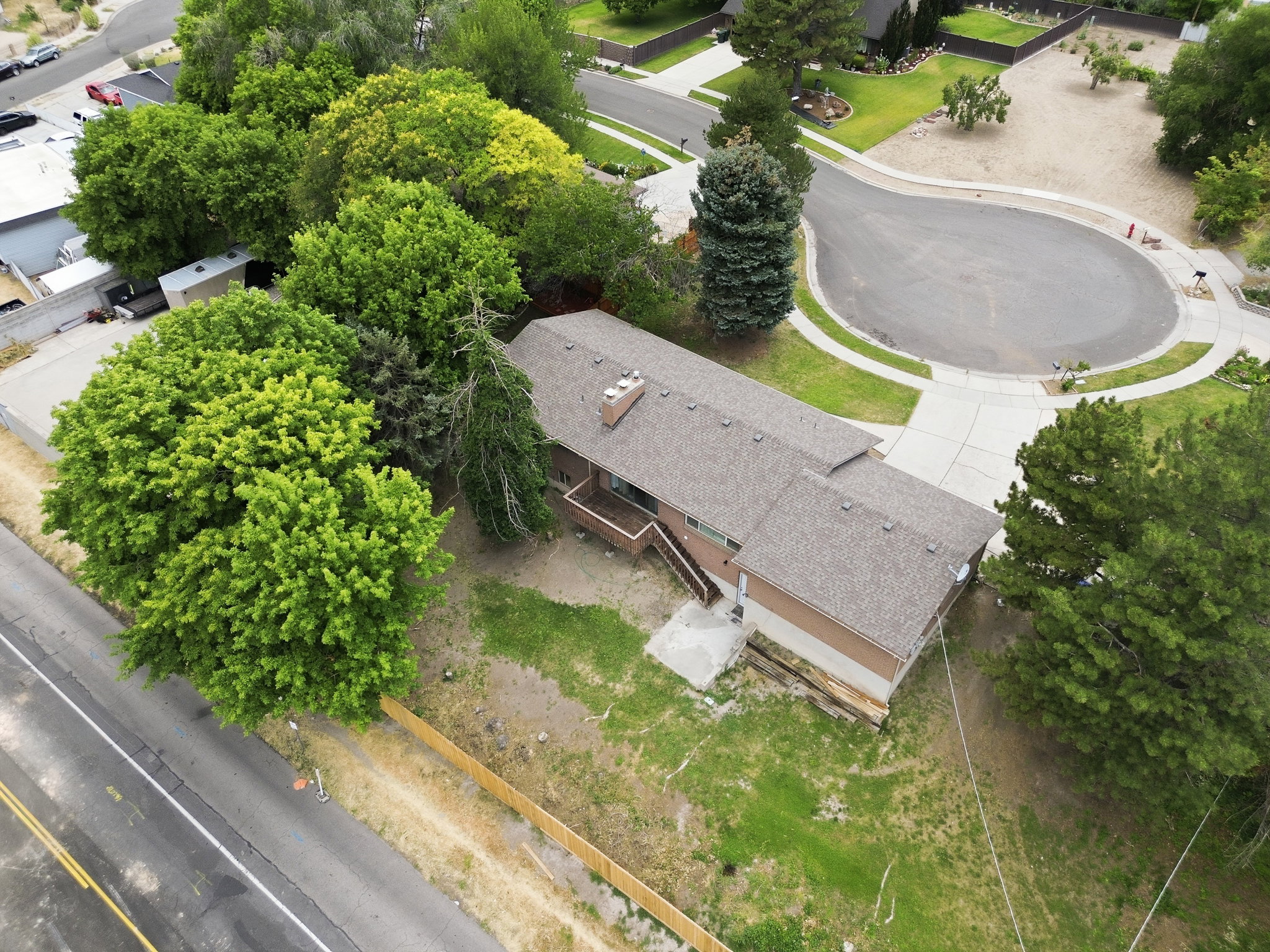 Single-story residence featuring a brown-toned exterior, an asphalt shingle roof, and a visible chimney