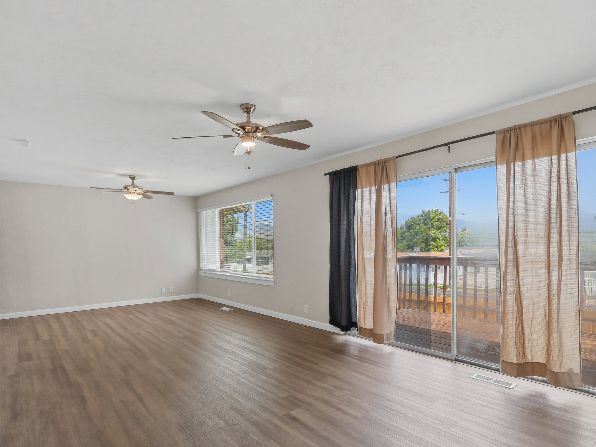 Spacious interior with wood-finish flooring and neutral wall tones