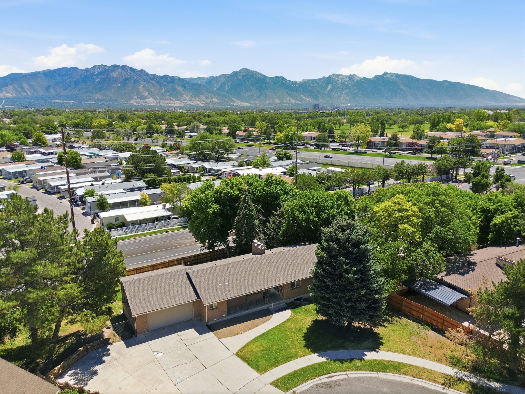 Overhead property perspective featuring a ranch-style home with an attached garage and a concrete driveway