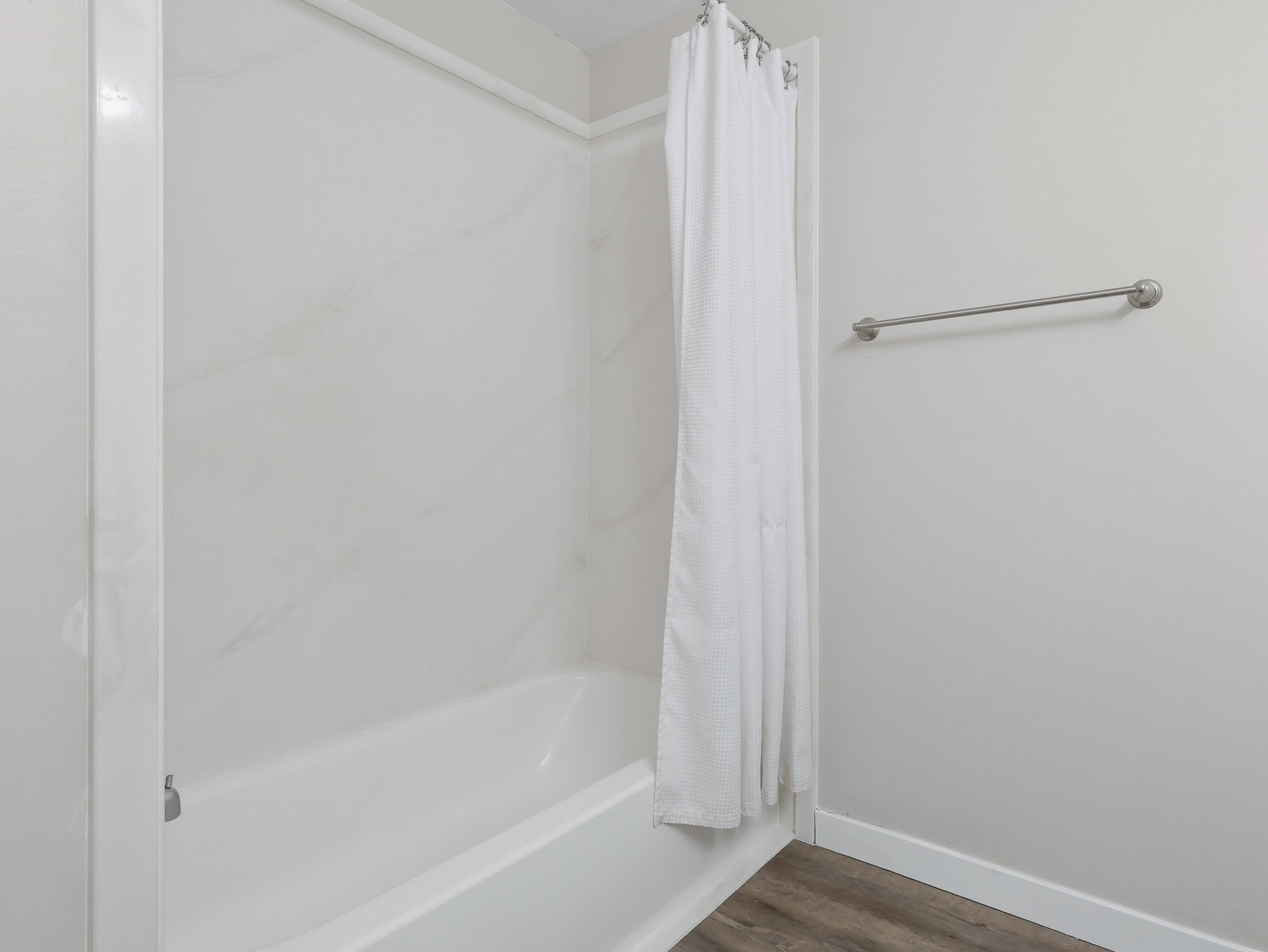 Tub and shower combination featuring white subway tile surround