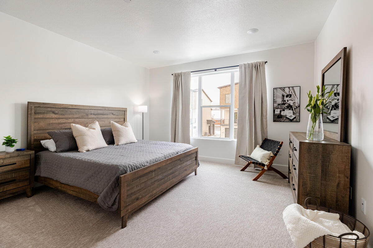 Primary bedroom with large walk in closet, large windows and full ensuite bathroom.