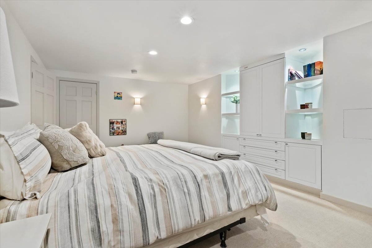 Built-in cabinetry featuring integrated lighting, shelving, and drawer storage