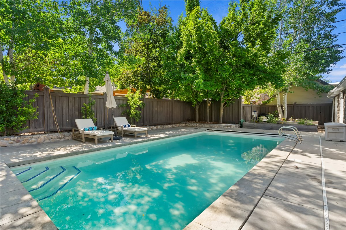 Rectangular swimming pool featuring integrated steps and a concrete surround