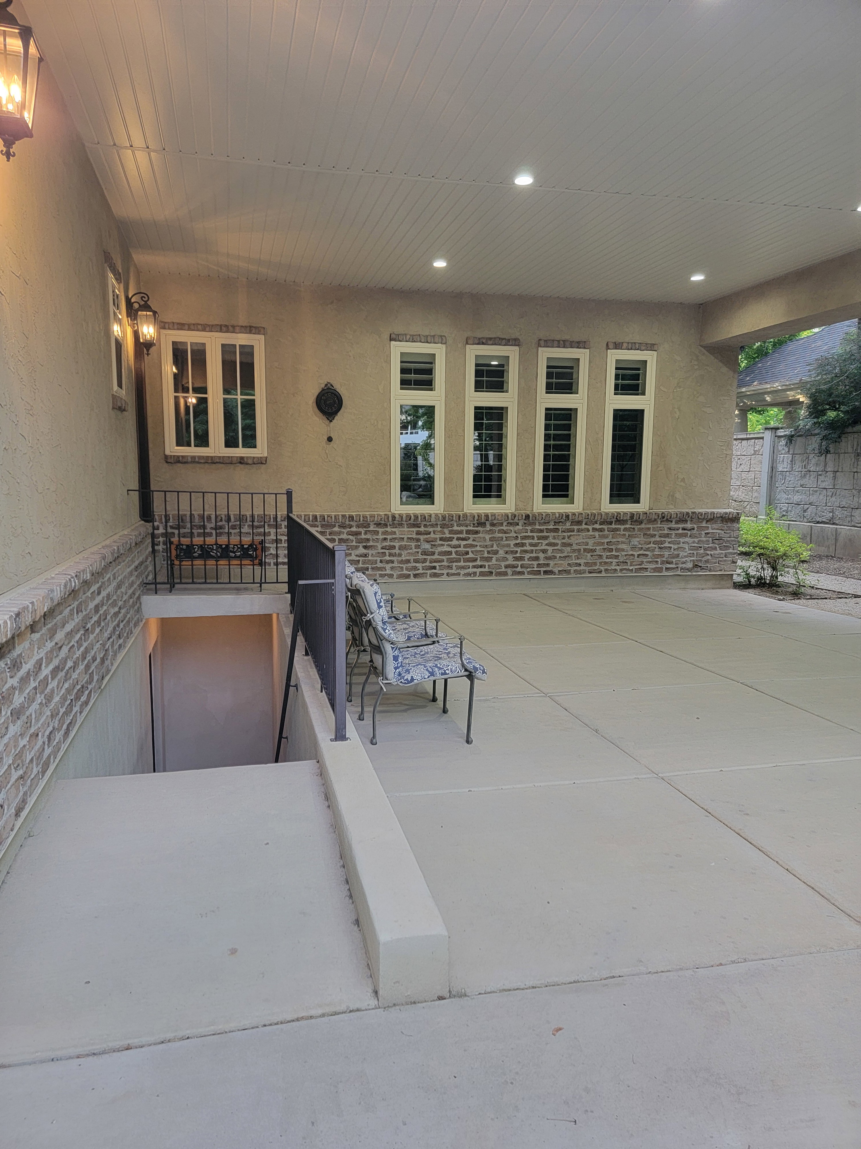 Covered outdoor patio area, also featuring  a covered basement entrance