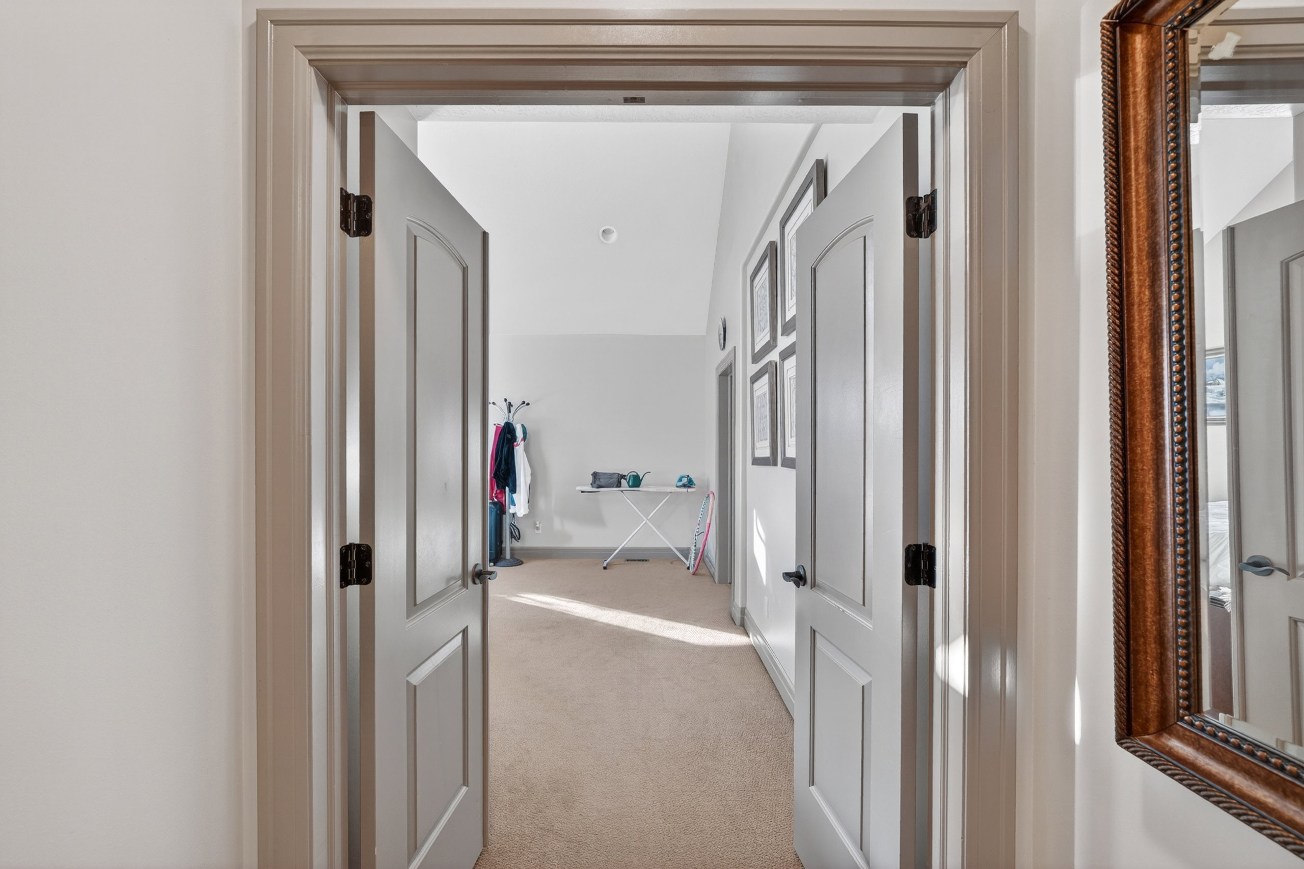 Interior doorway with paneled doors and dark hardware