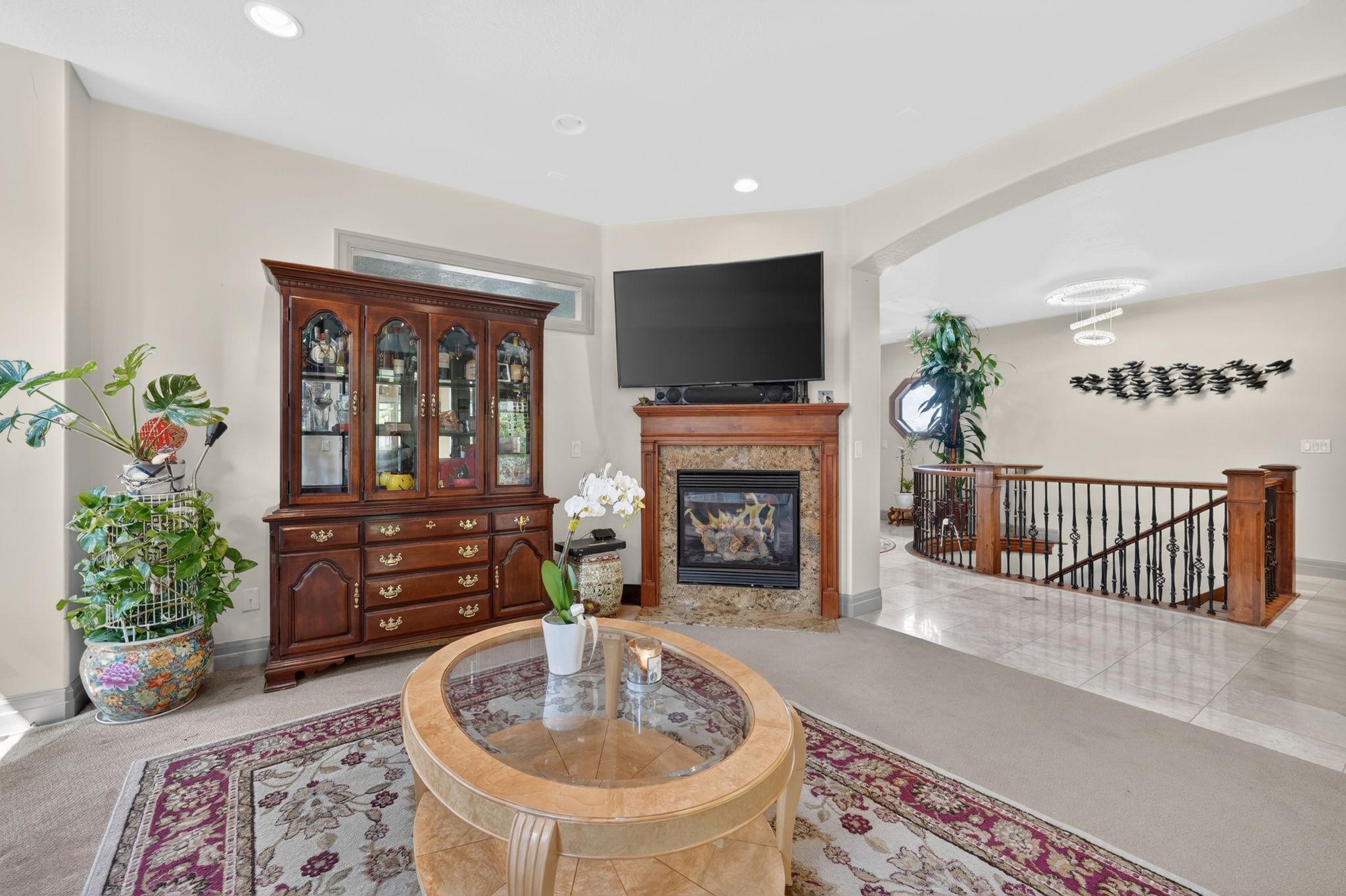 Living area featuring a fireplace with a stone surround and wood mantel