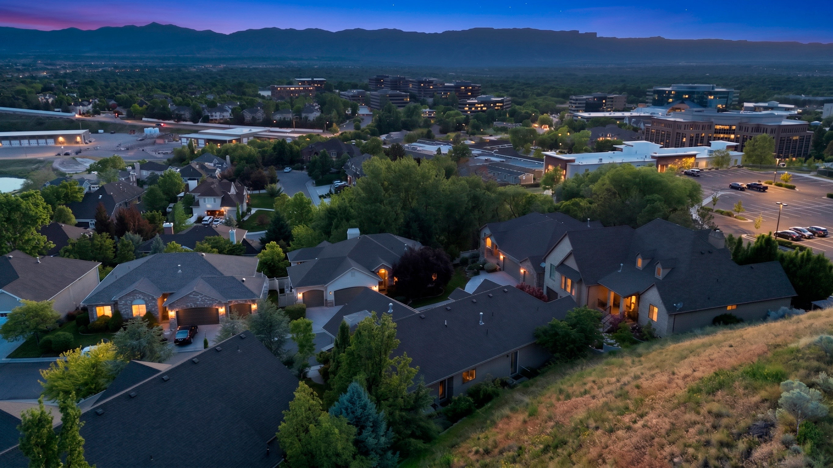 Aerial perspective of a residential neighborhood with distant mountain ranges