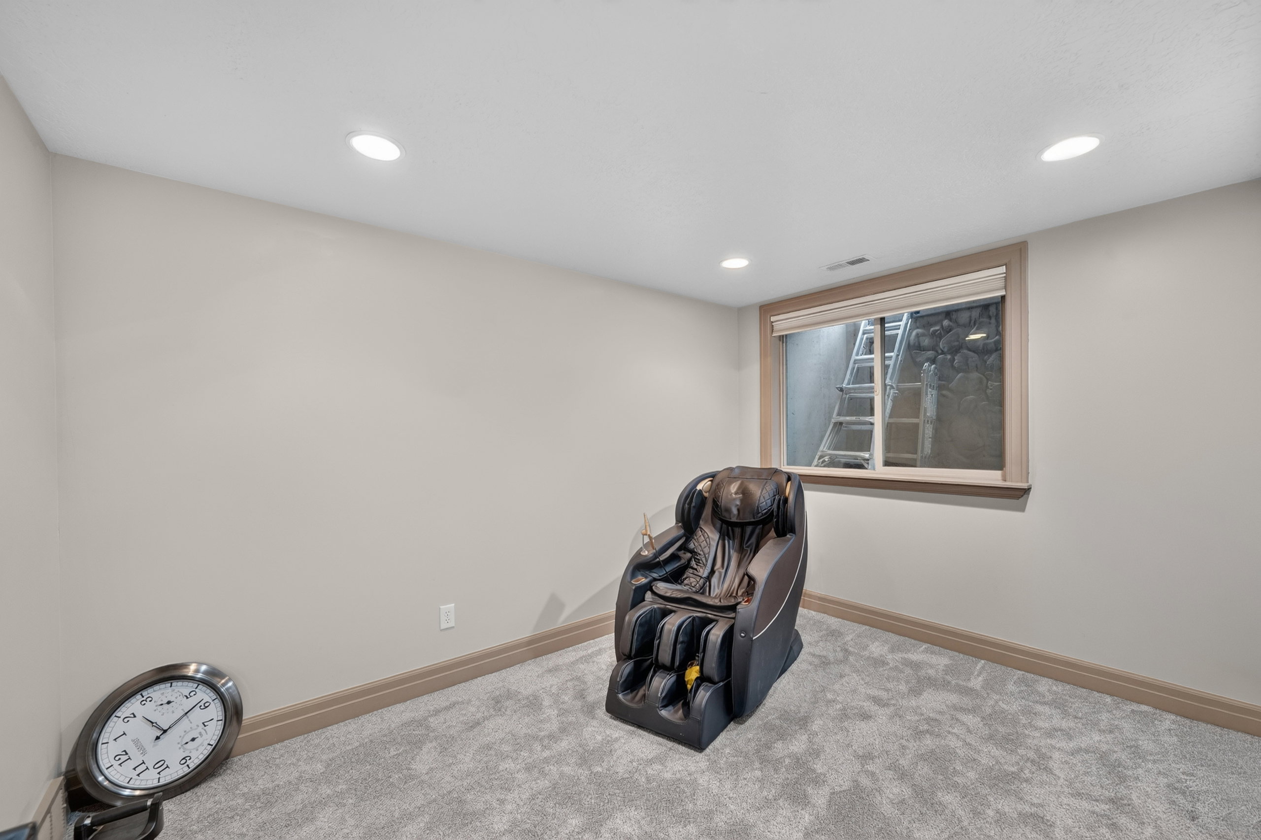 Carpeted room featuring recessed lighting, a window with wood trim, and neutral-toned walls