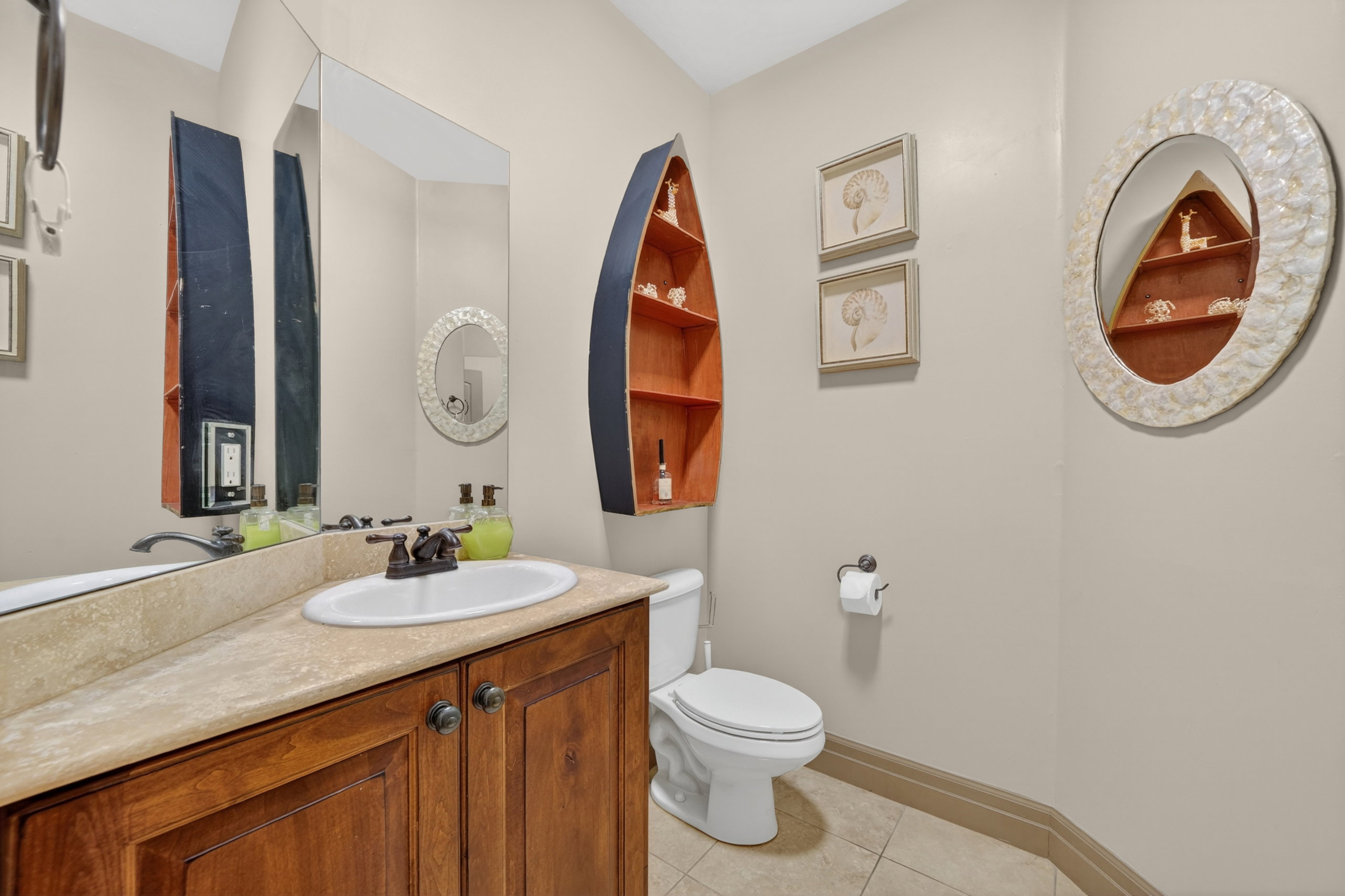 Bathroom featuring a wood vanity with a light-colored countertop and an undermount sink