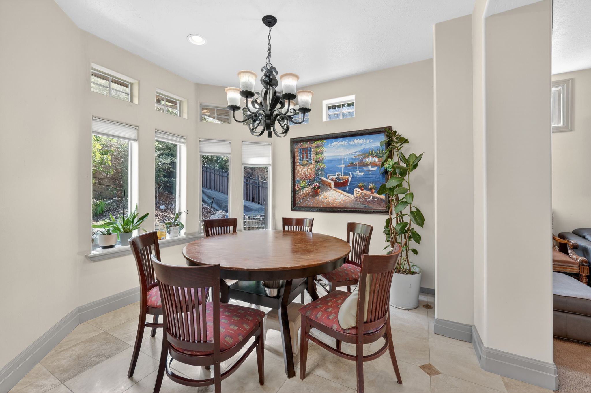 Dining area featuring a bay window, recessed lighting, a decorative chandelier, and tile flooring