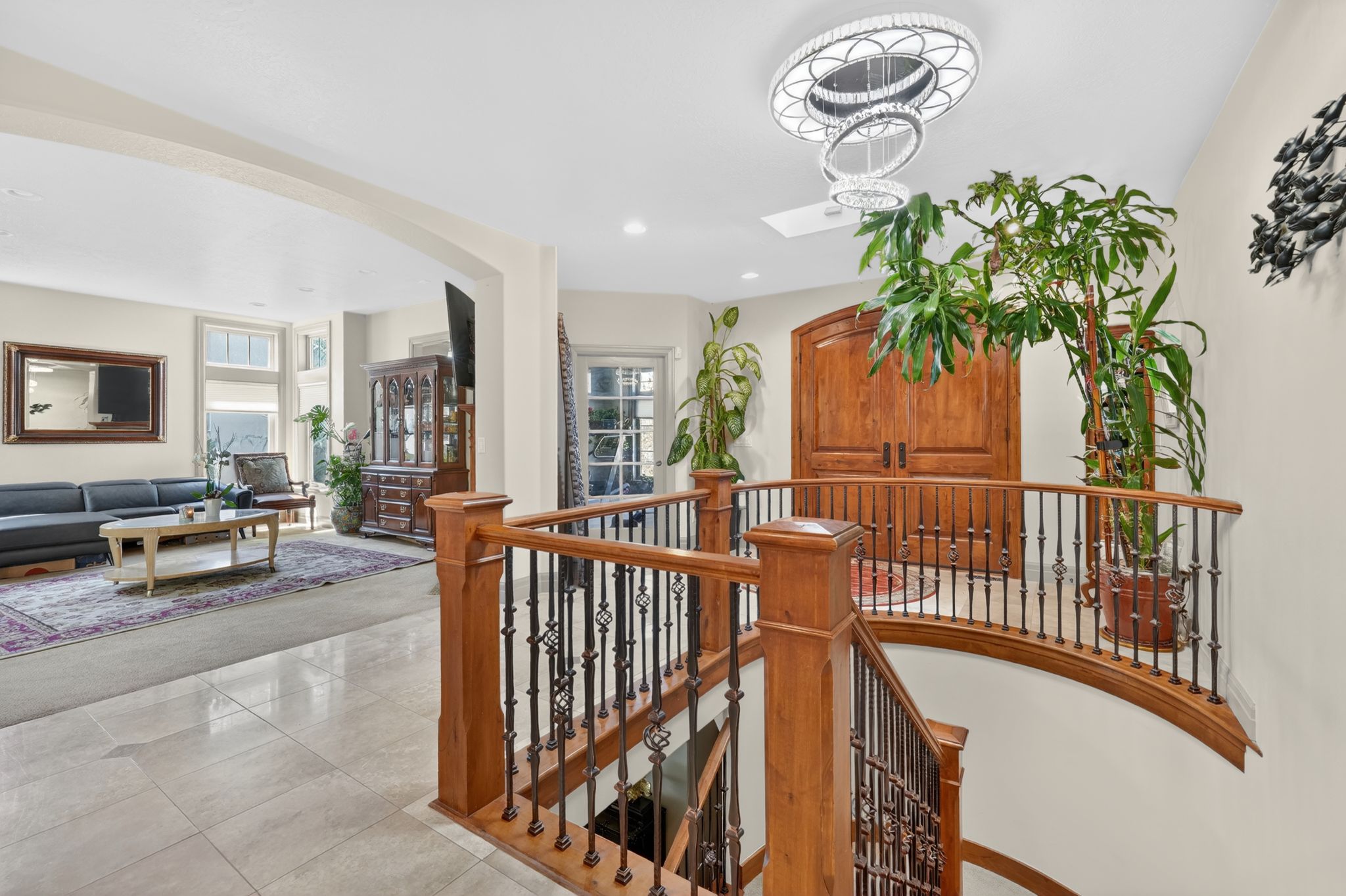 Curved staircase with wood newel posts and wrought iron balusters