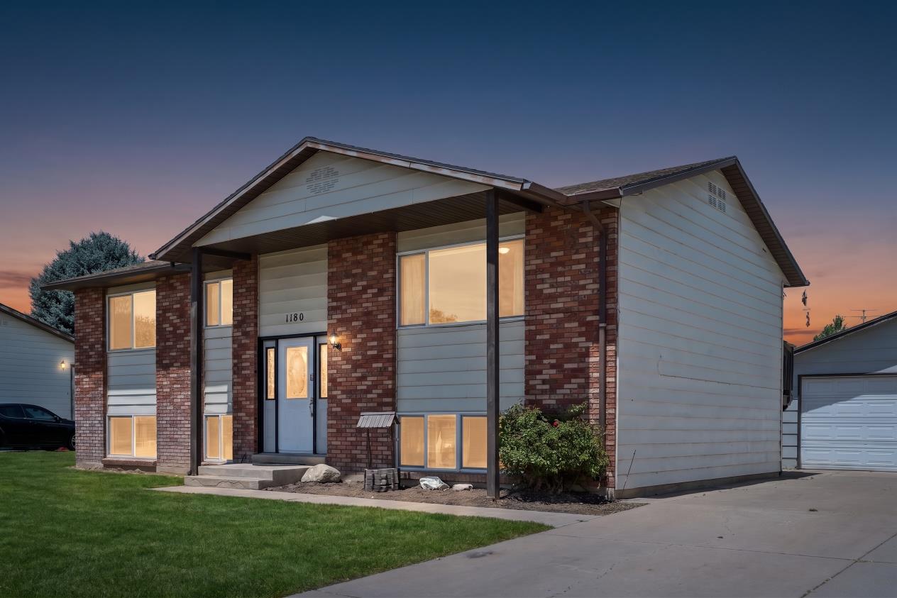 Split-level residence featuring a brick and siding exterior (Digitally enhanced to show lawn potential)