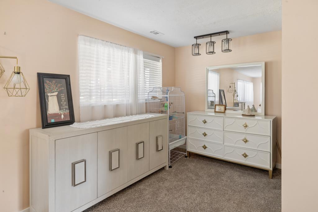 Room featuring neutral wall tones and textured carpeting