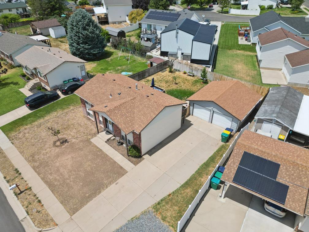 Residential property featuring a detached two-car garage, concrete driveway, and established neighborhood setting