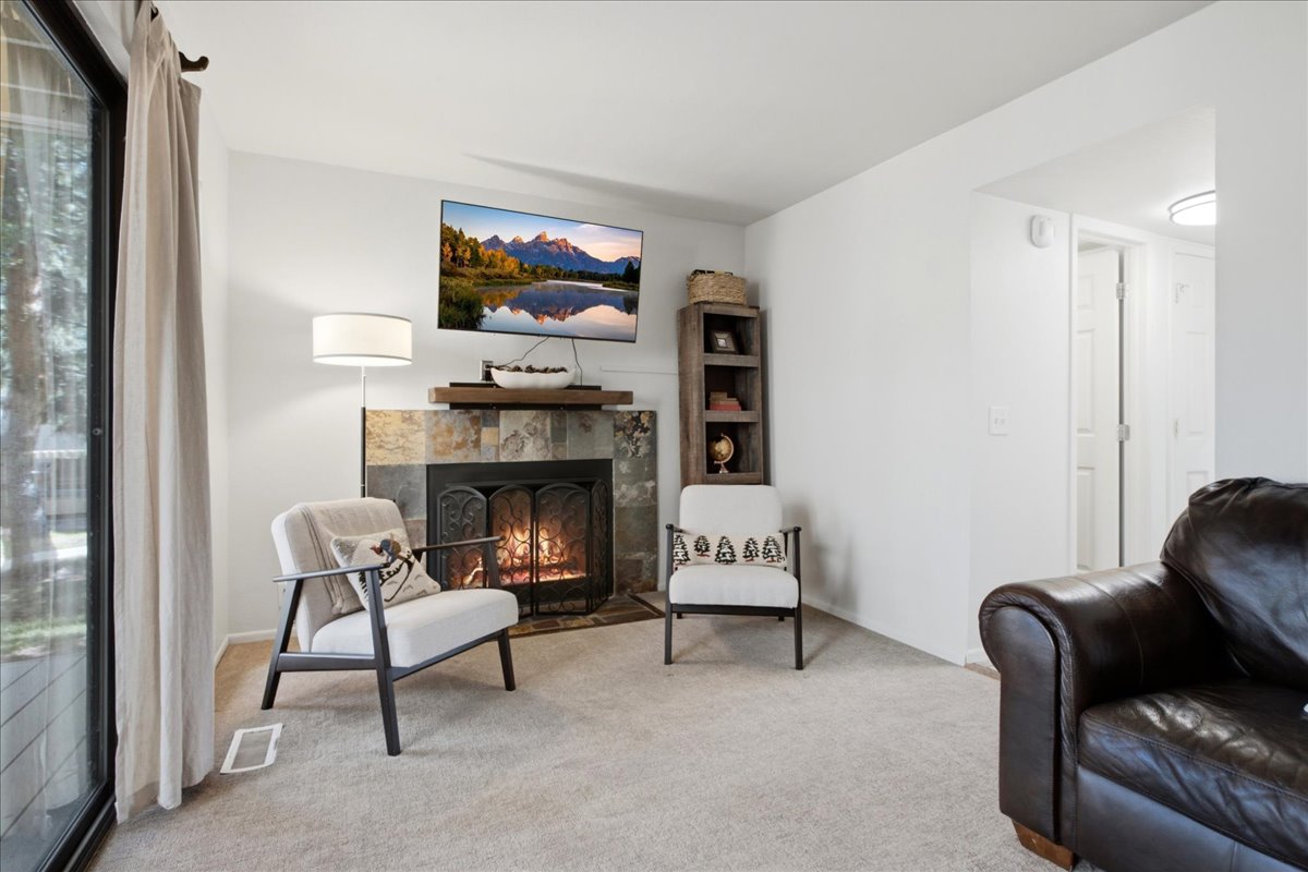 This warm and inviting living space features a cozy gas fireplace.