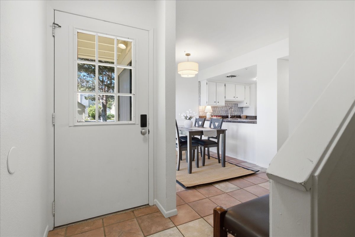 Keyless entry front door opens directly into the bright main-level dining and kitchen areas.