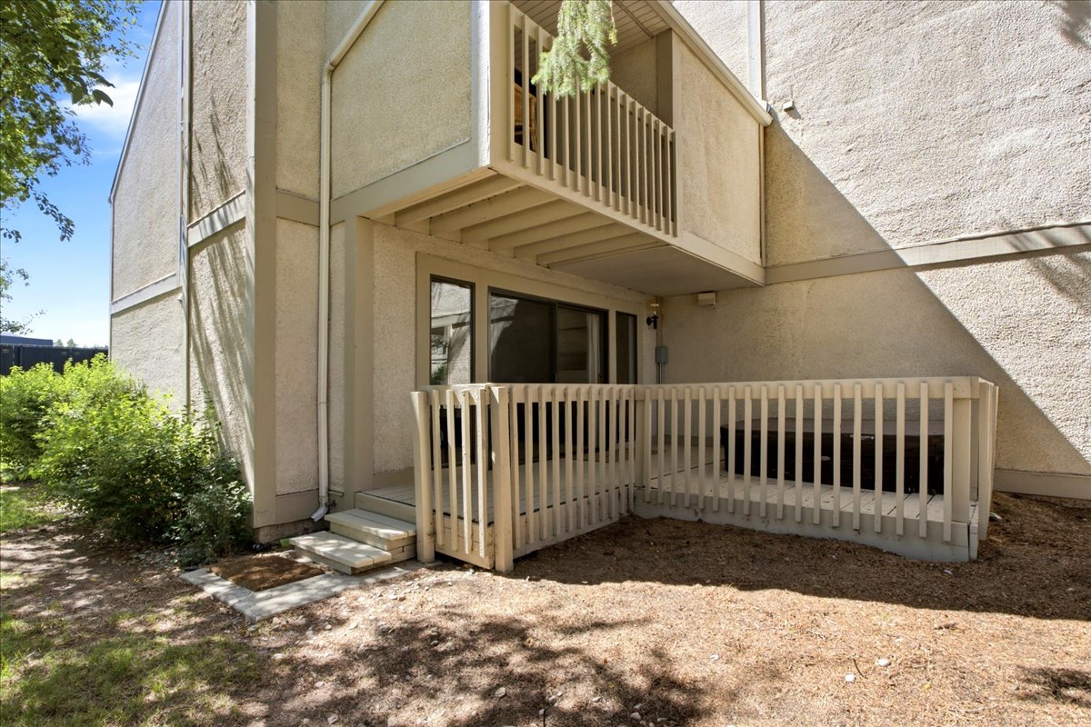 Expansive back deck features a built-in hot tub.