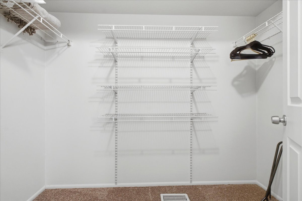 Spacious primary walk-in closet.