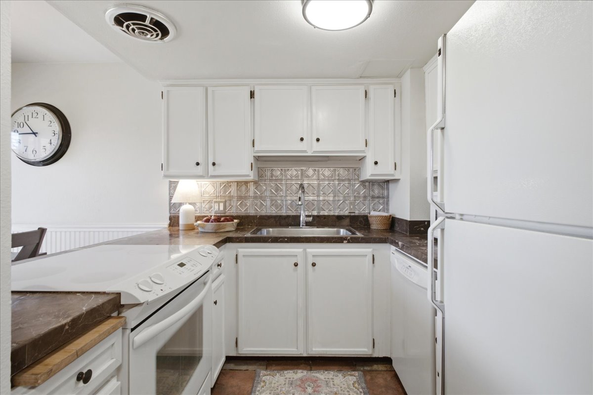 Functional Kitchen with bright white cabinetry.