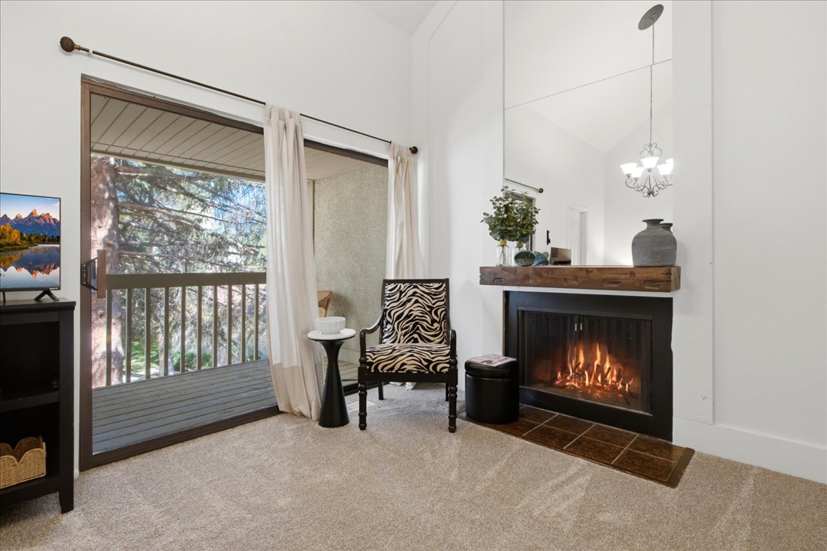 Bedroom sanctuary features extra sitting room and a cozy fireplace.