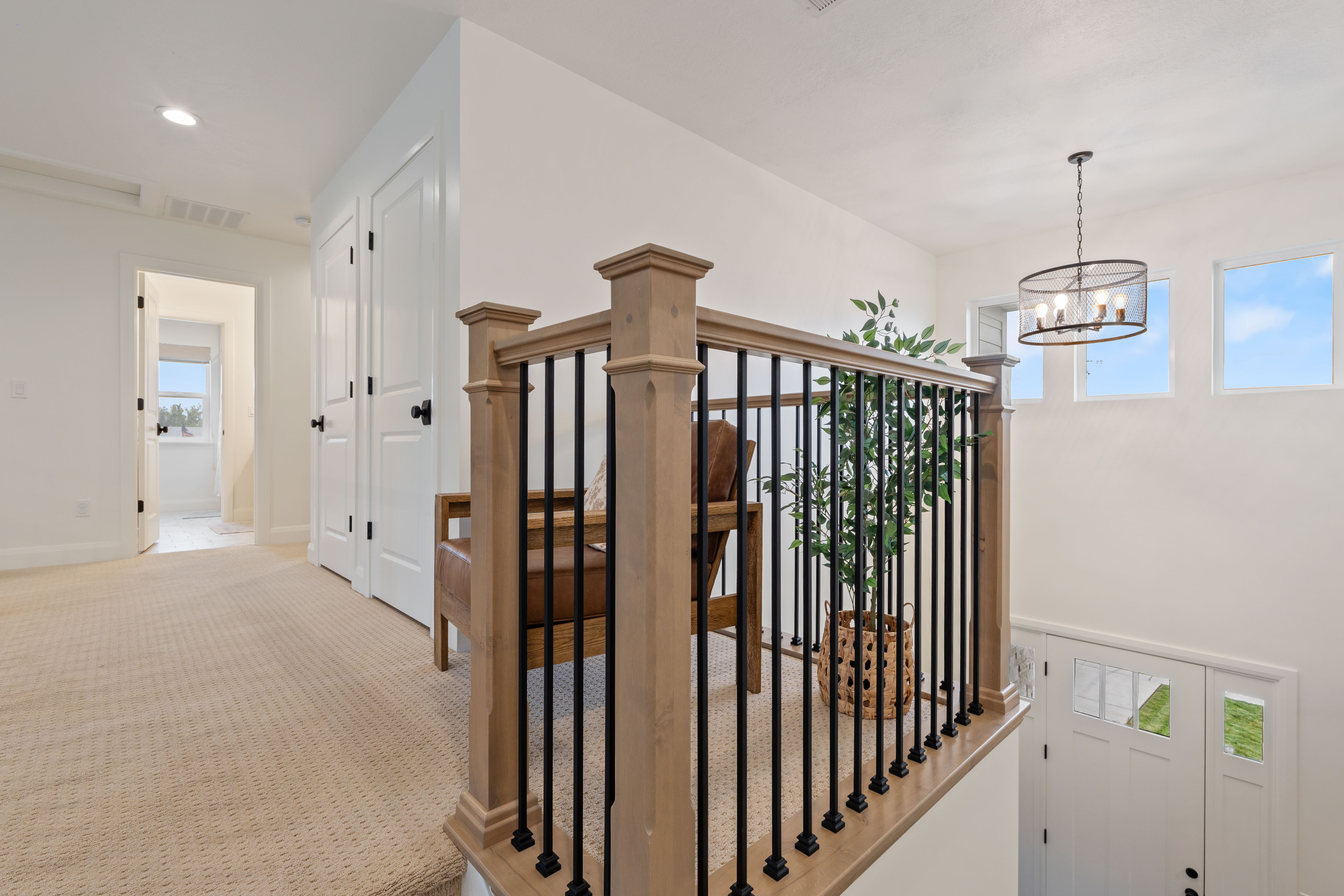Upper-level hallway with neutral carpeting and white interior doors