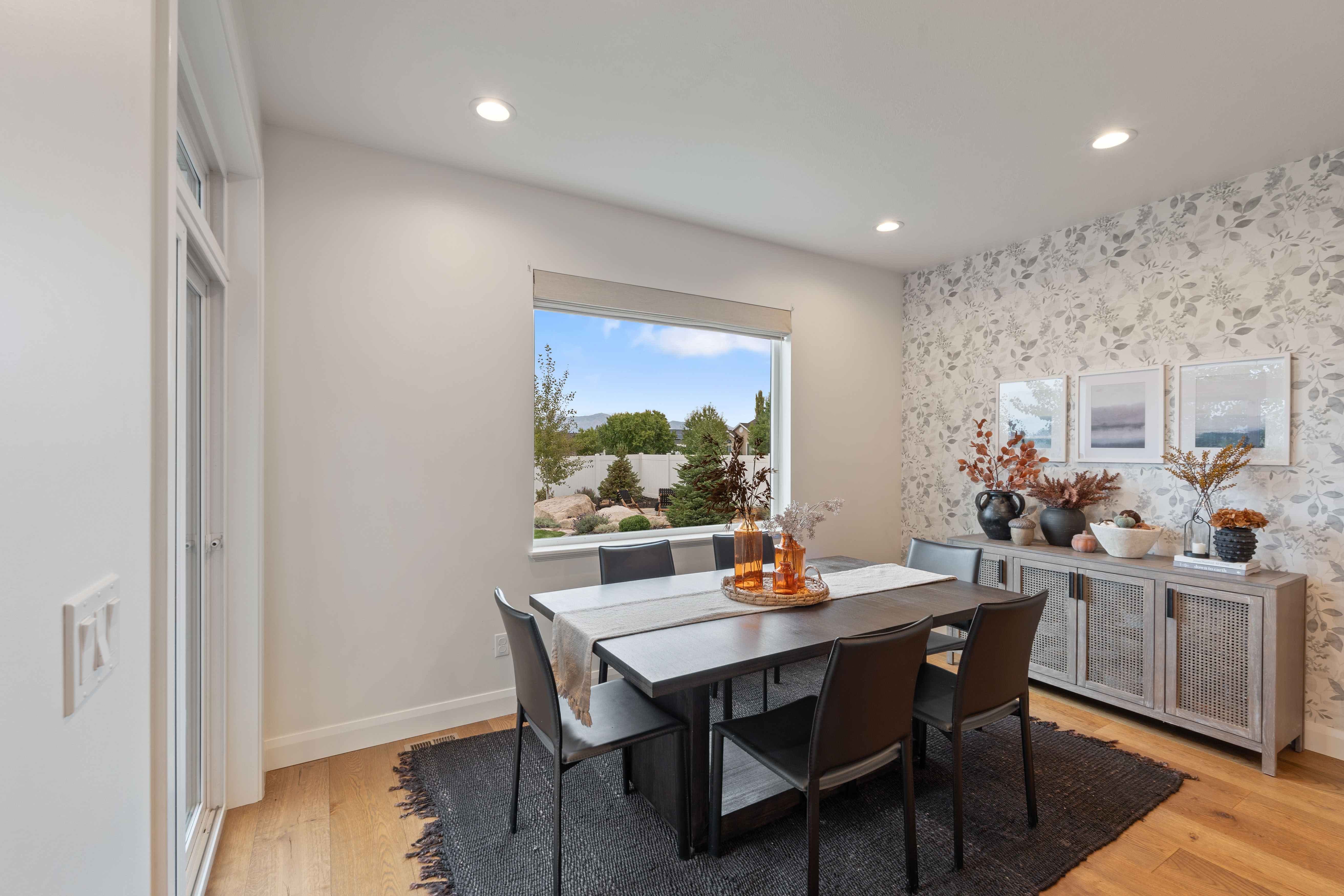Dining area featuring wood-finish flooring, a large picture window, and recessed lighting