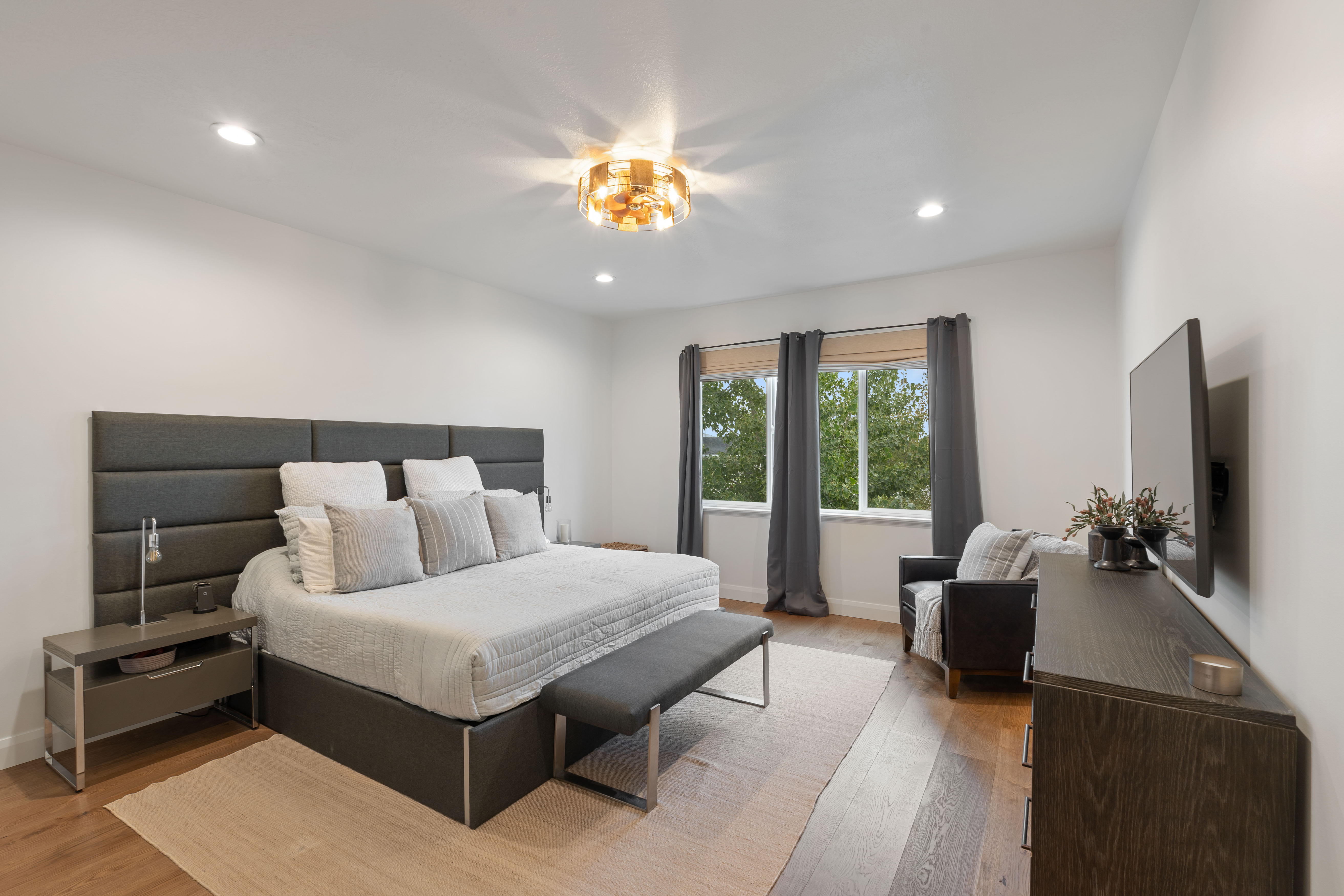 Master on Main - Spacious room featuring wood-finish flooring, recessed lighting, and a contemporary ceiling fixture