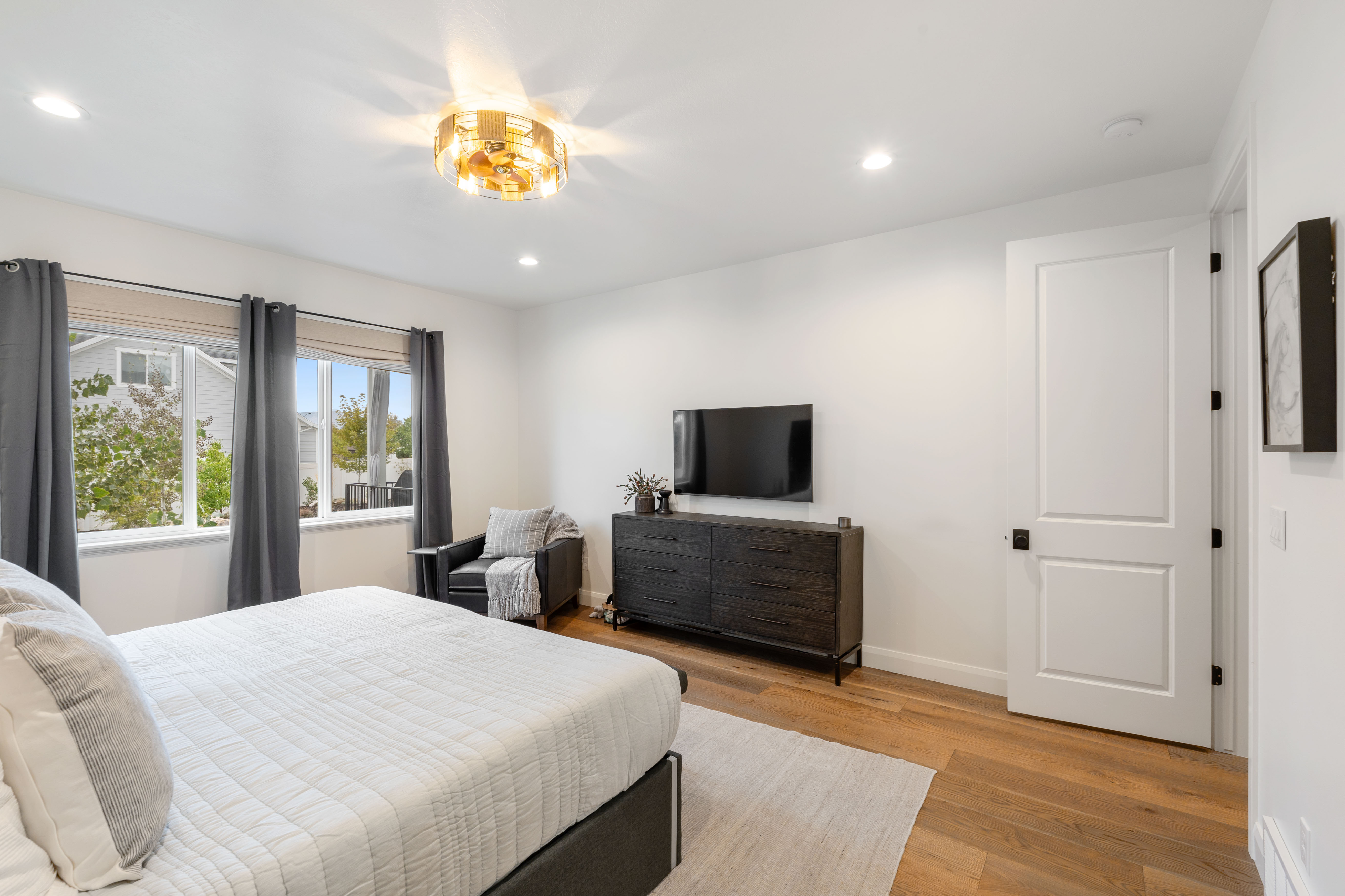 Hardwood-finish flooring complements the bright white walls and recessed lighting
