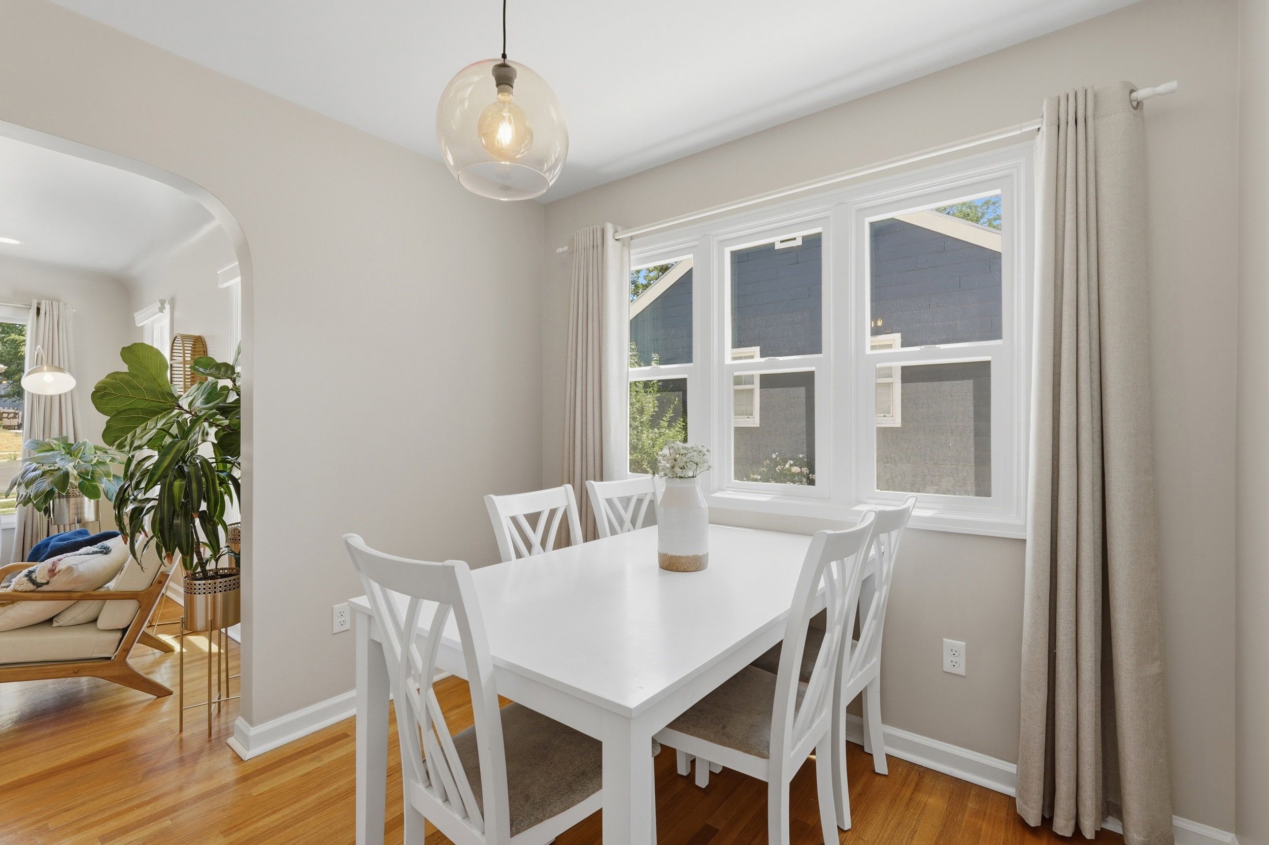 Dining area featuring wood-finish flooring and an arched doorway
